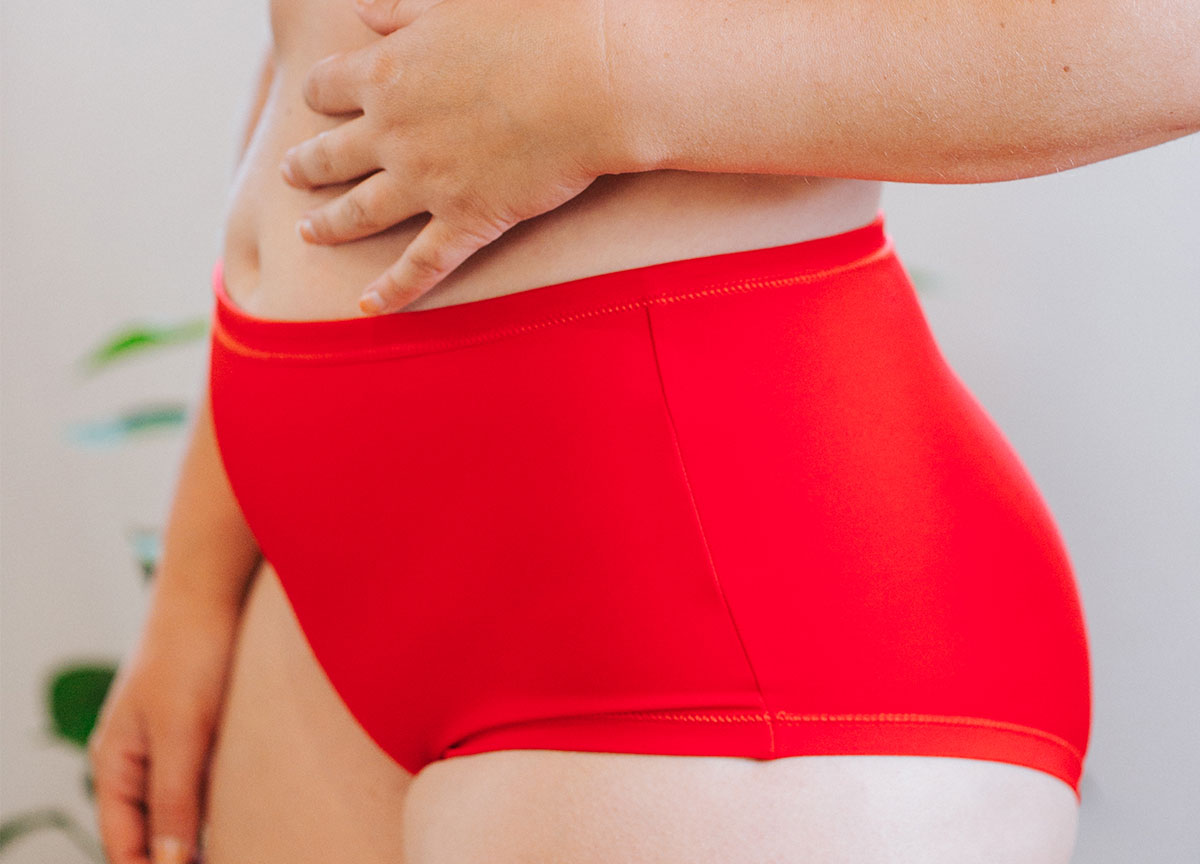 Model wearing Swimwear Original Style Bottoms in Classic Red.