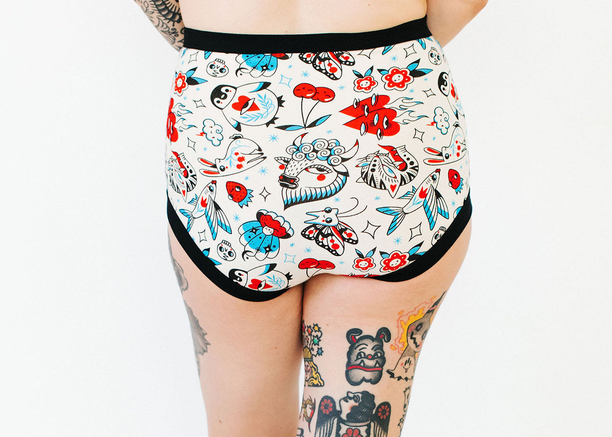 Model wearing Thunderpants Sky Rise style underwear in Inked Up - blue, red, and black tattoos.