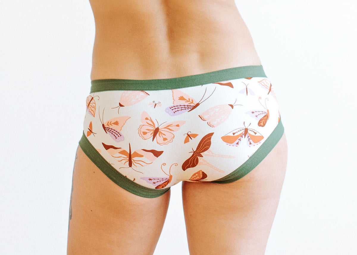 Model wearing Thunderpants Hipster style underwear in Field Study - brown, pink, and purple moths and butterflies.