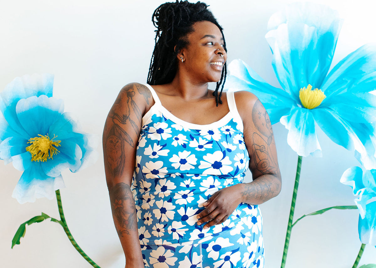 Close up of model wearing Thunderpants Cami and Leggings in Moody Blooms - blue and white flowers.