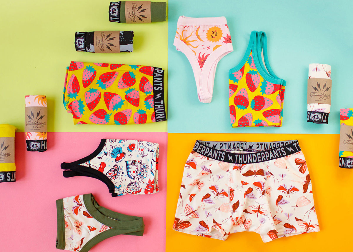 Flat lay of various Thunderpants styles in different prints on a colorful background.