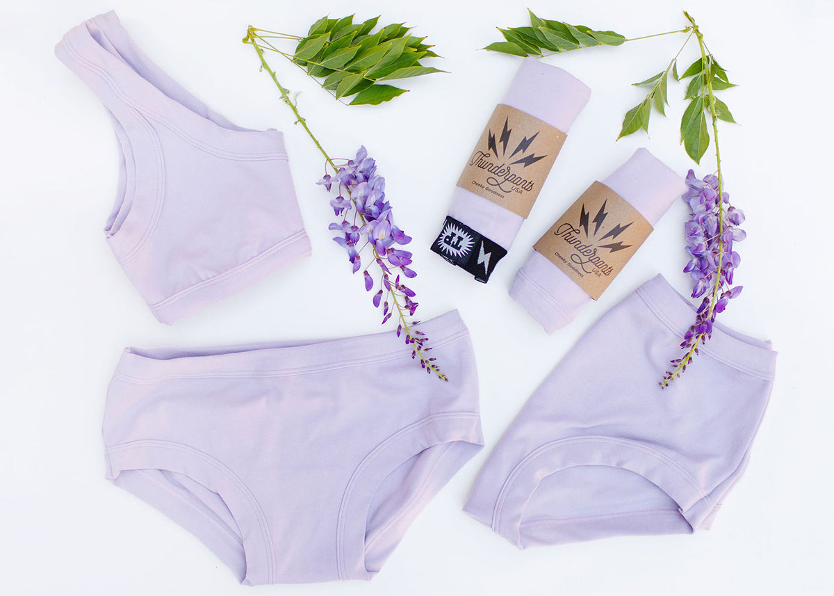 Different Thunderpants items on a white background in Wisterial Girl - purple/grey solid color.