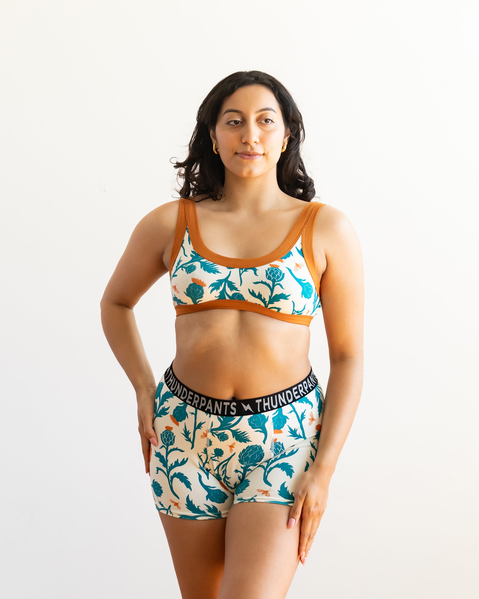 Model wearing Thunderpants Boxer Brief style underwear and Bralette in Robben's Artichokes print - teal and rust artichokes and bees.