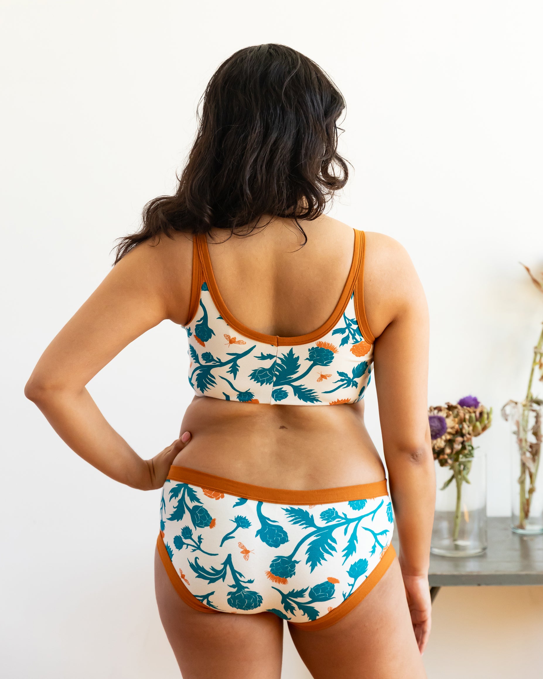 Model wearing Thunderpants Hipster style underwear and Longline Bra in Robben's Artichokes print - teal and rust artichokes and bees.
