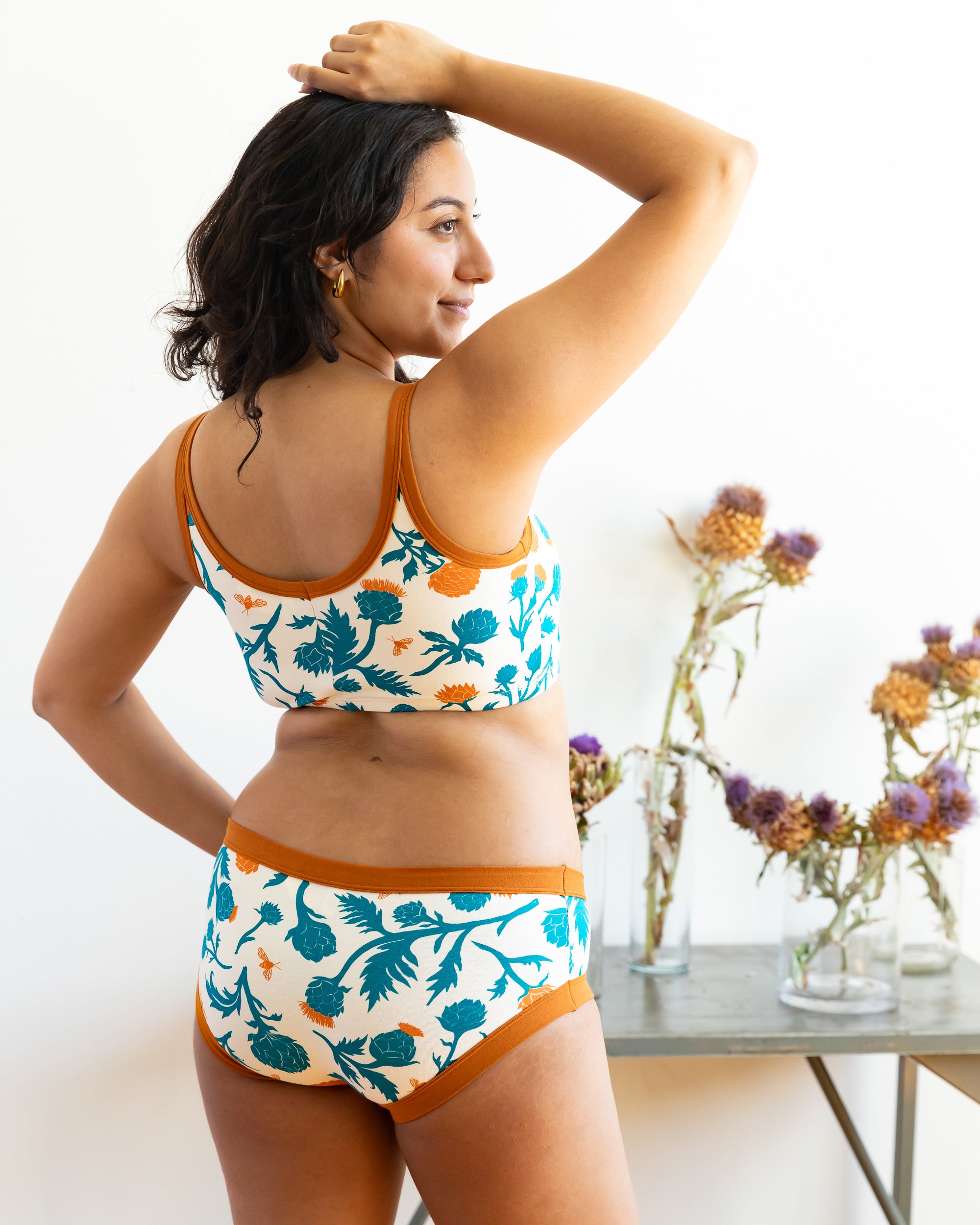 Model wearing Thunderpants Hipster style underwear and Longline Bra in Robben's Artichokes print - teal and rust artichokes and bees.