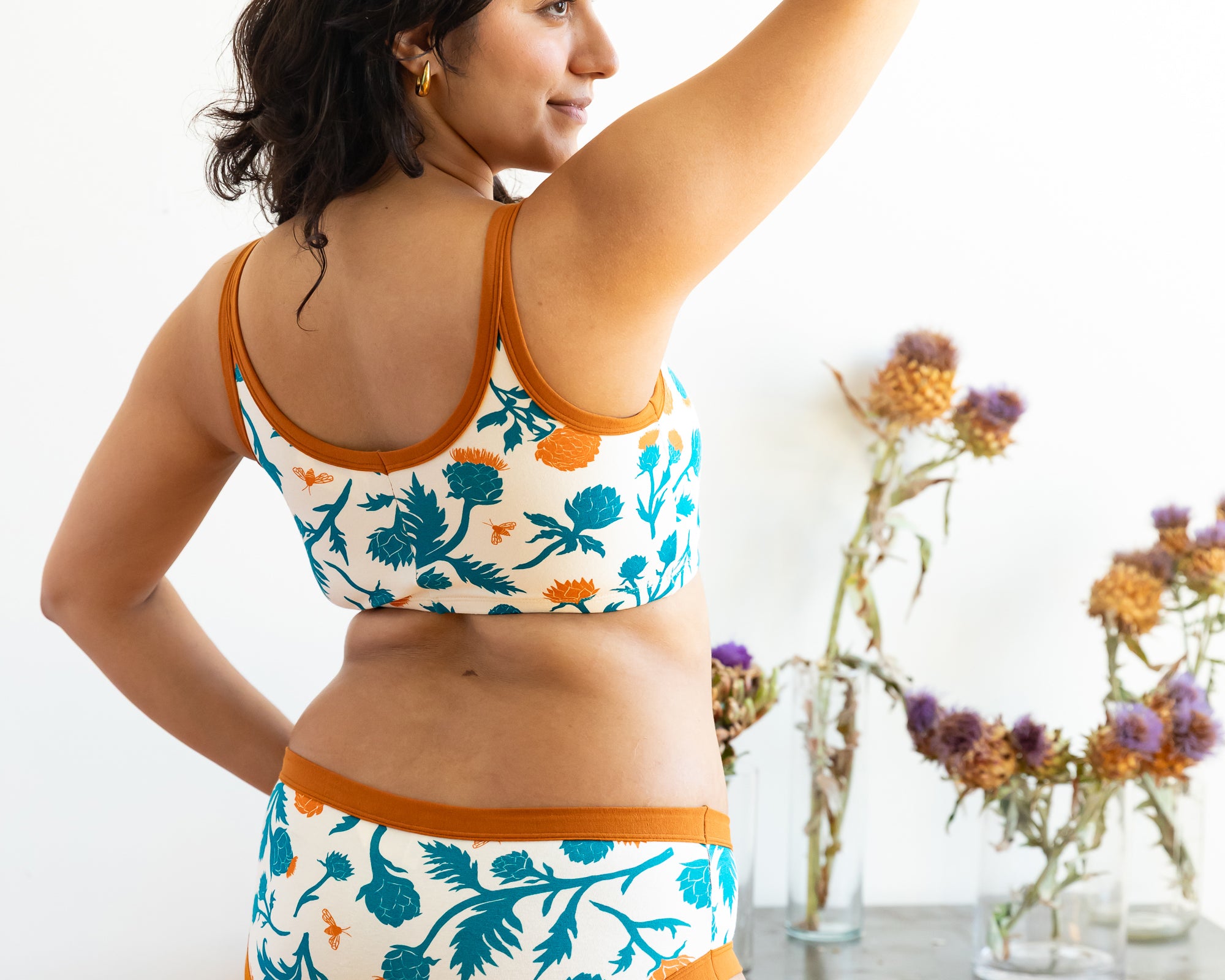Model wearing Thunderpants Hipster style underwear and Longline Bra in Robben's Artichokes print - teal and rust artichokes and bees.