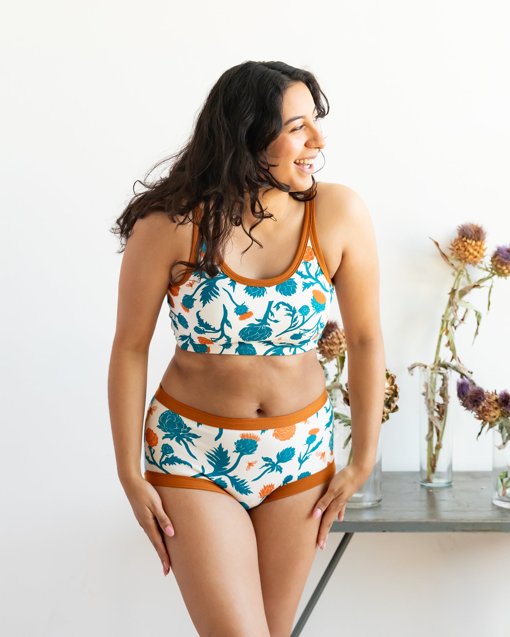 Model wearing Thunderpants Original style underwear and Longline bra in Robben's Artichokes print - teal and rust artichokes and bees.