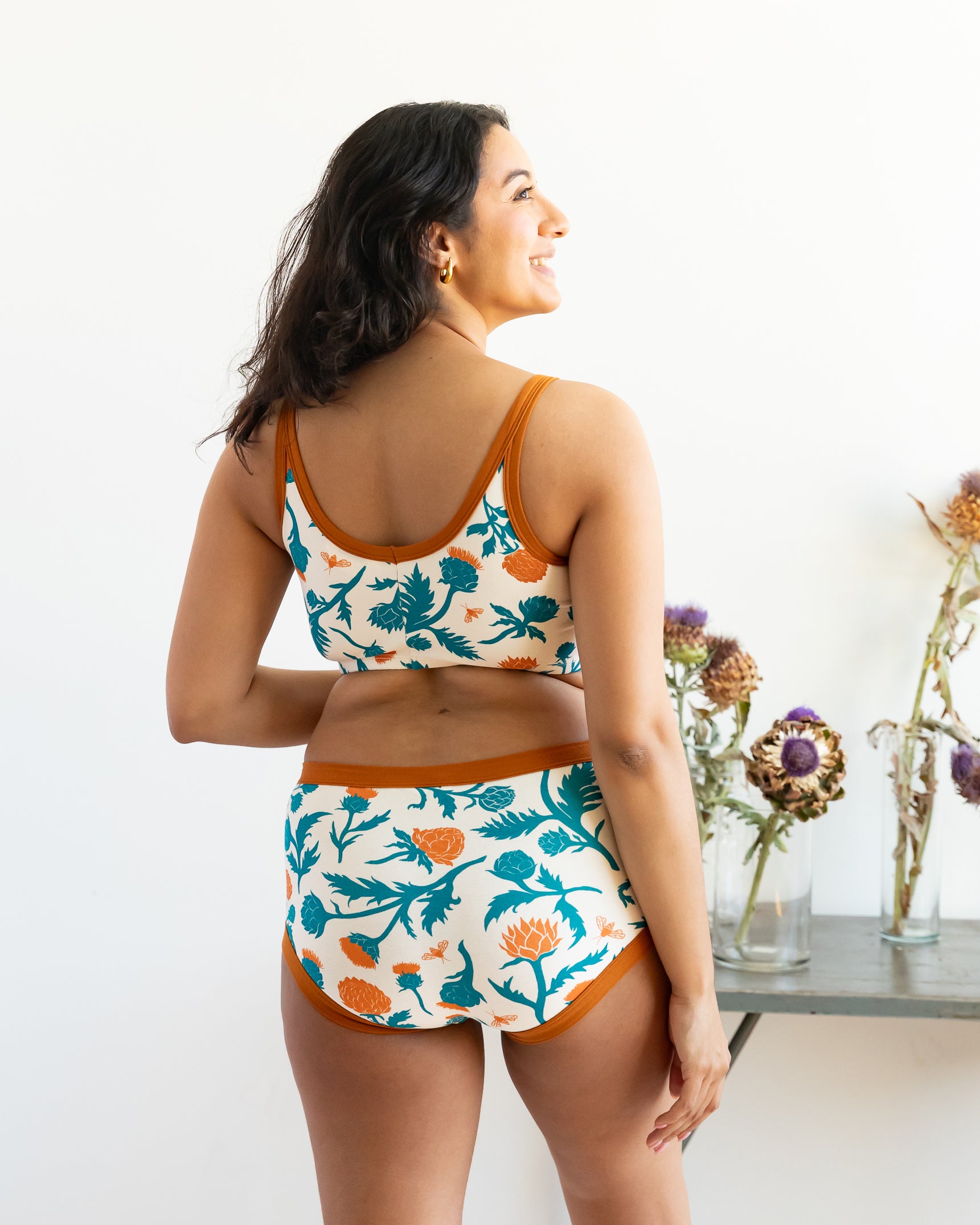 Model wearing Thunderpants Original style underwear and Longline bra in Robben's Artichokes print - teal and rust artichokes and bees.