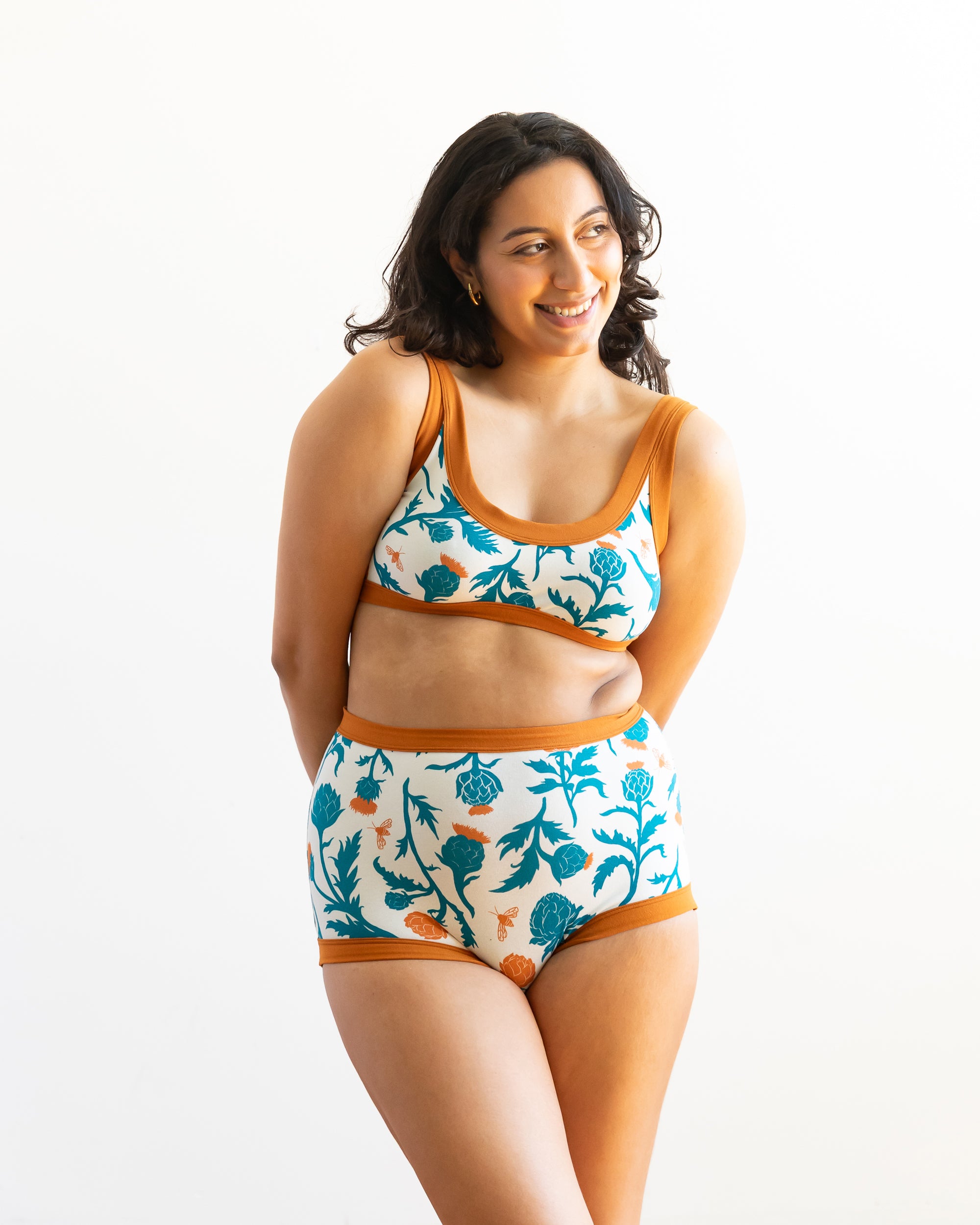 Model wearing Thunderpants Sky Rise style underwear and Bralette in Robben's Artichokes print - teal and rust artichokes and bees.