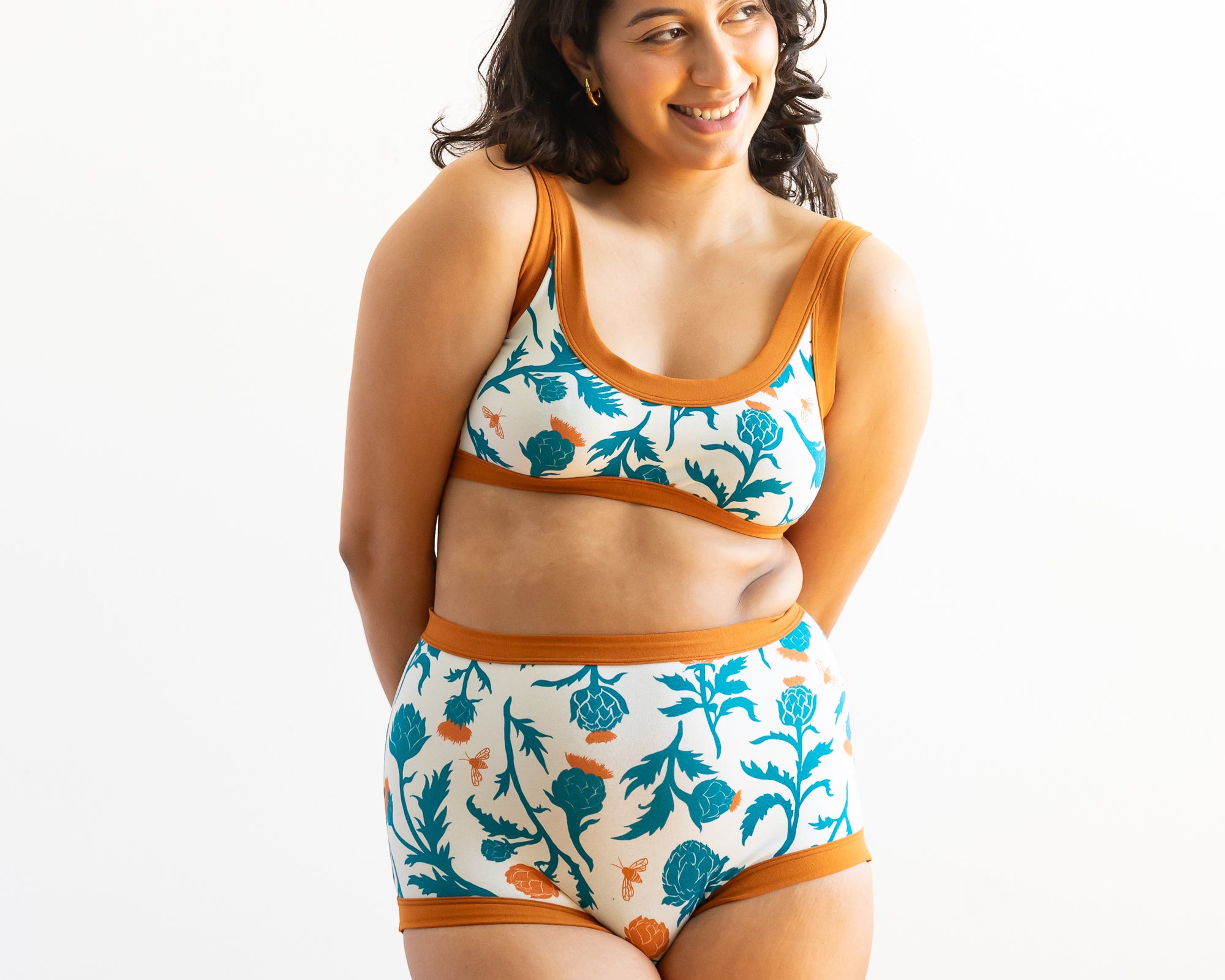 Model wearing Thunderpants Sky Rise style underwear and Bralette in Robben's Artichokes print - teal and rust artichokes and bees.