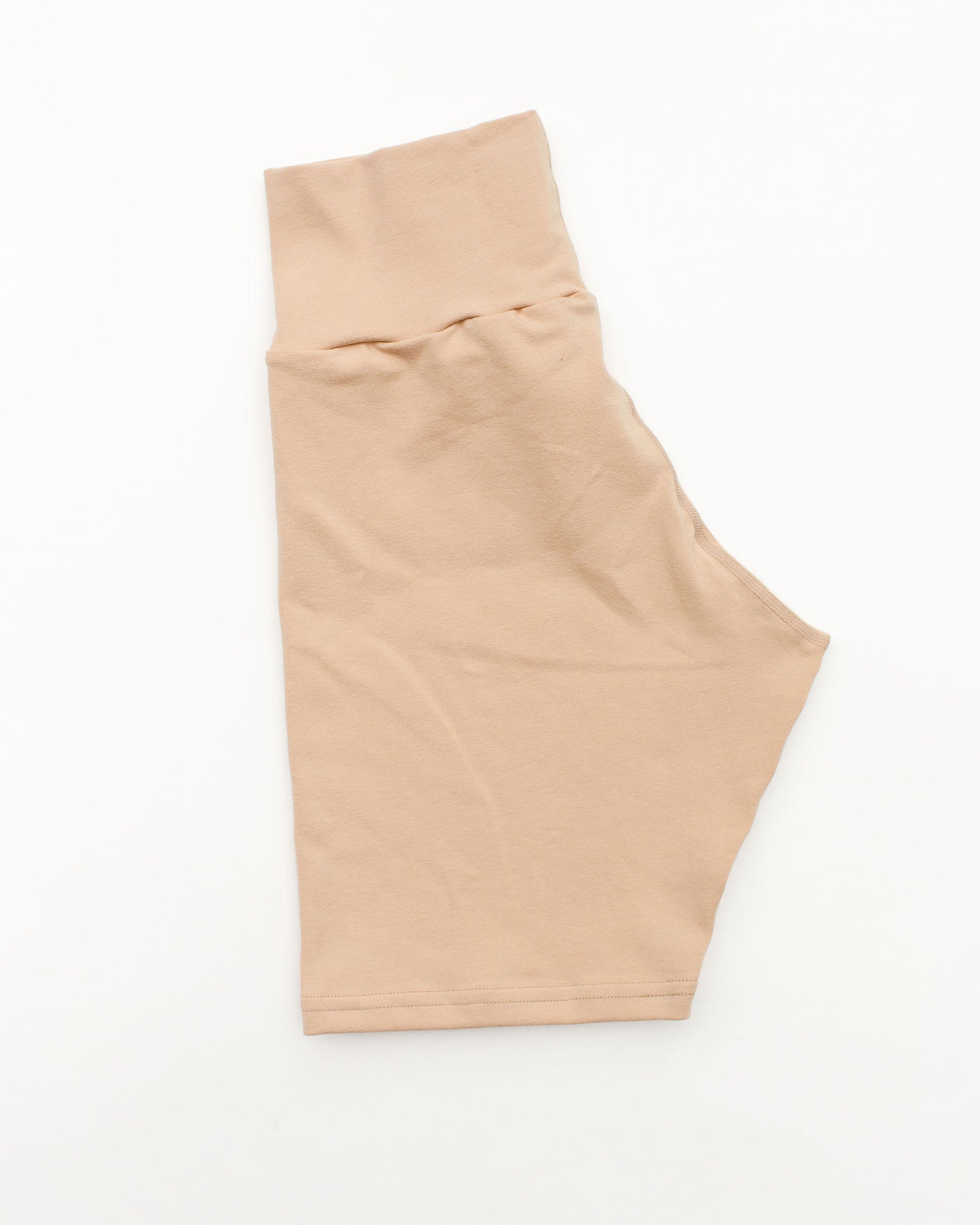 Flat lay of Thunderpants Bike Shorts in Pine Nut color - a lighter tan.
