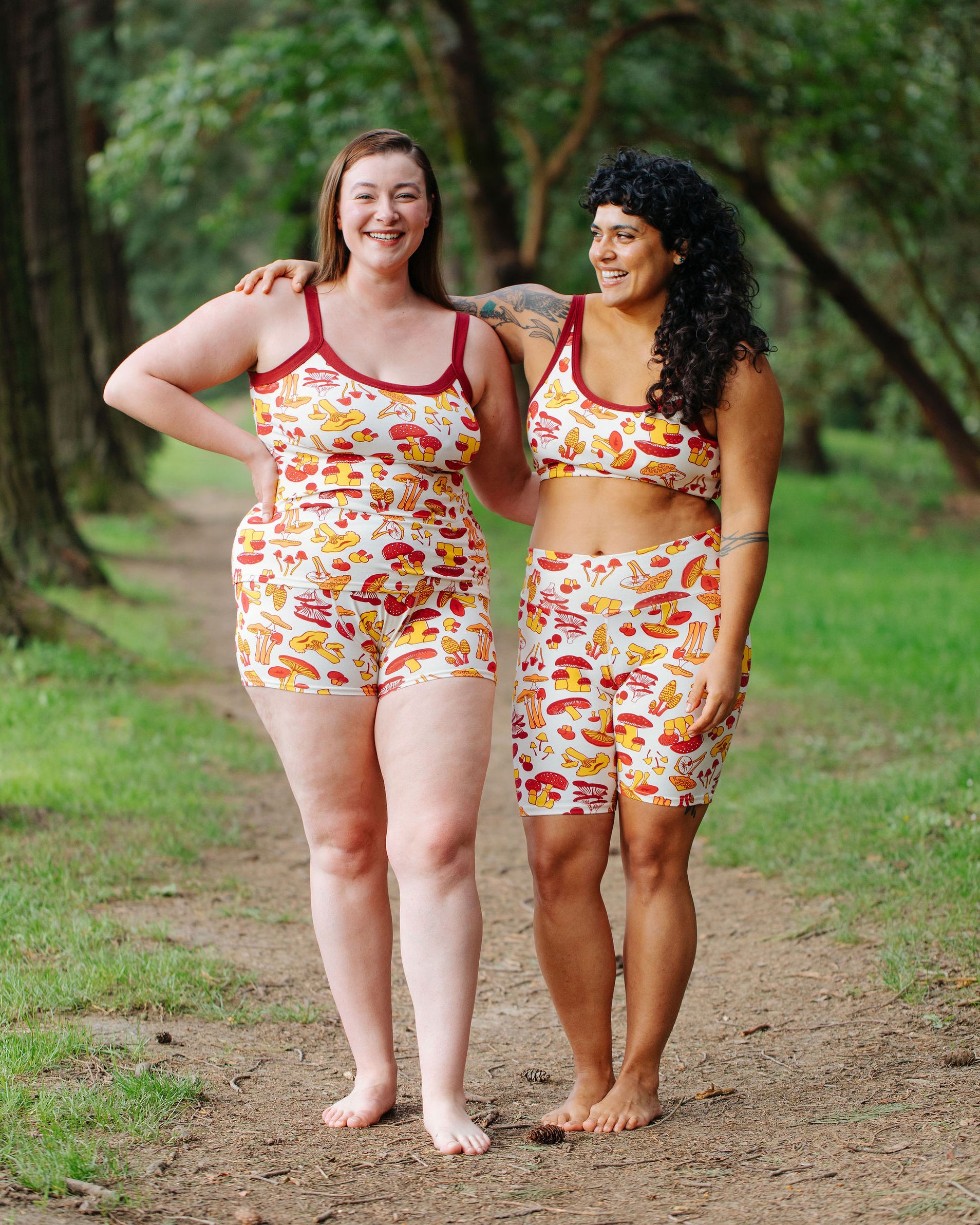 Two models wearing various Thunderpants items in Whadda Fungi - red, yellow, and orange mushroom print.