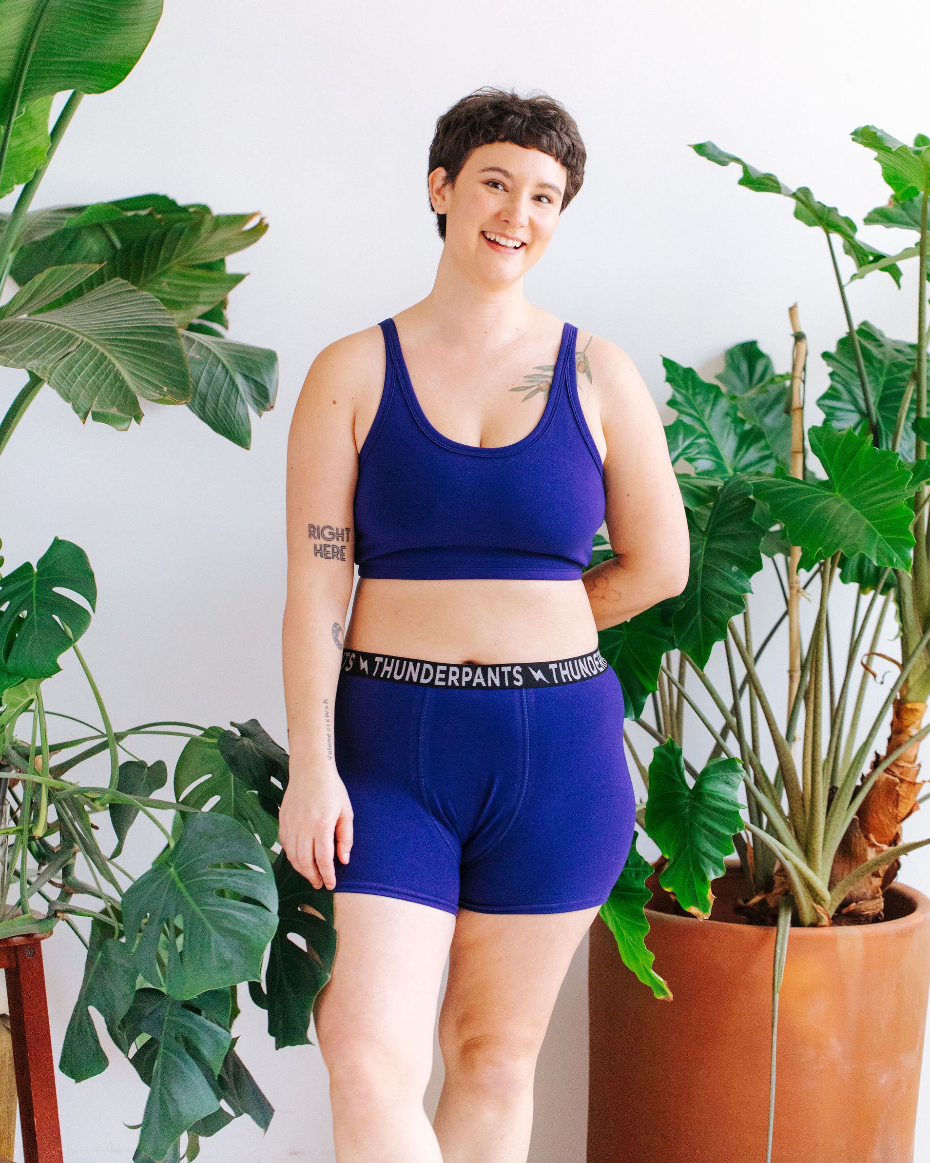 Model wearing Thunderpants Boxer Brief style underwear and Longline Bra in Indigo blue.