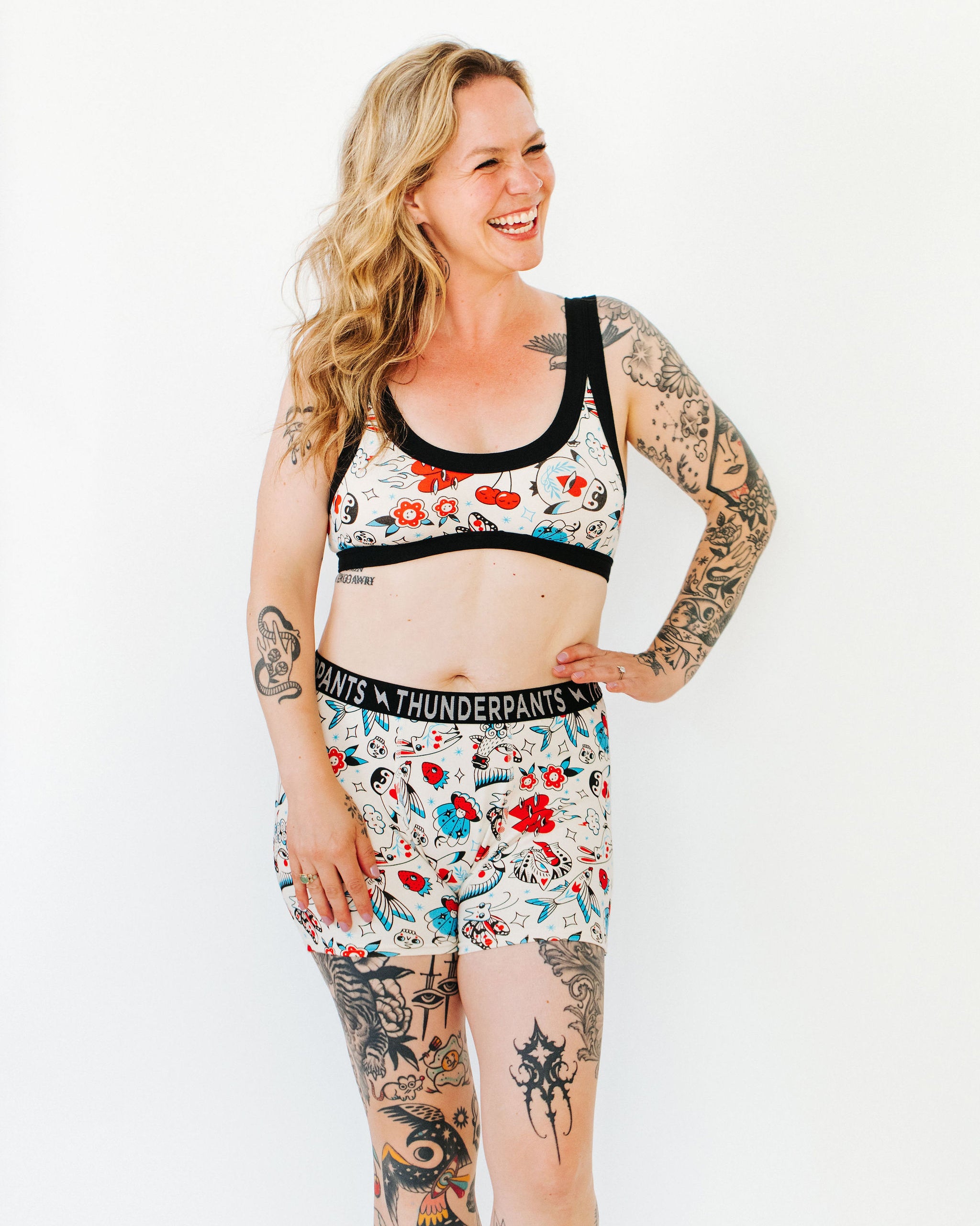 Model wearing Thunderpants Boxer Brief style underwear and Bralette in Inked Up - a tattoo pattern with black, red, and blue. 