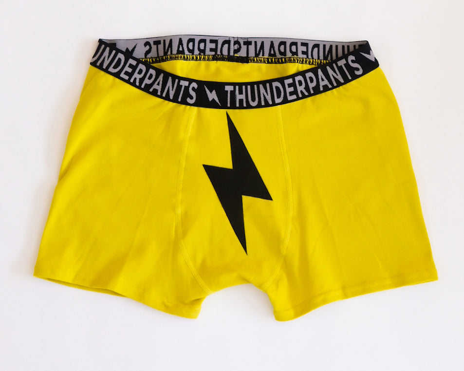 Flat lay of Thunderpants Boxer Brief style underwear in Thunderstruck - yellow with a black lightning bolt.