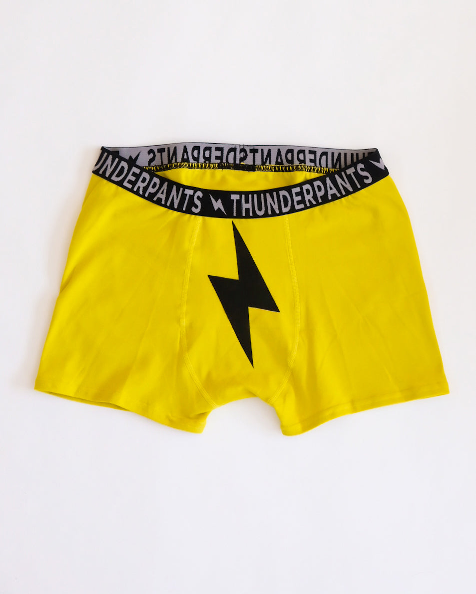 Flat lay of Thunderpants Boxer Brief style underwear in Thunderstruck - yellow with a black lightning bolt.