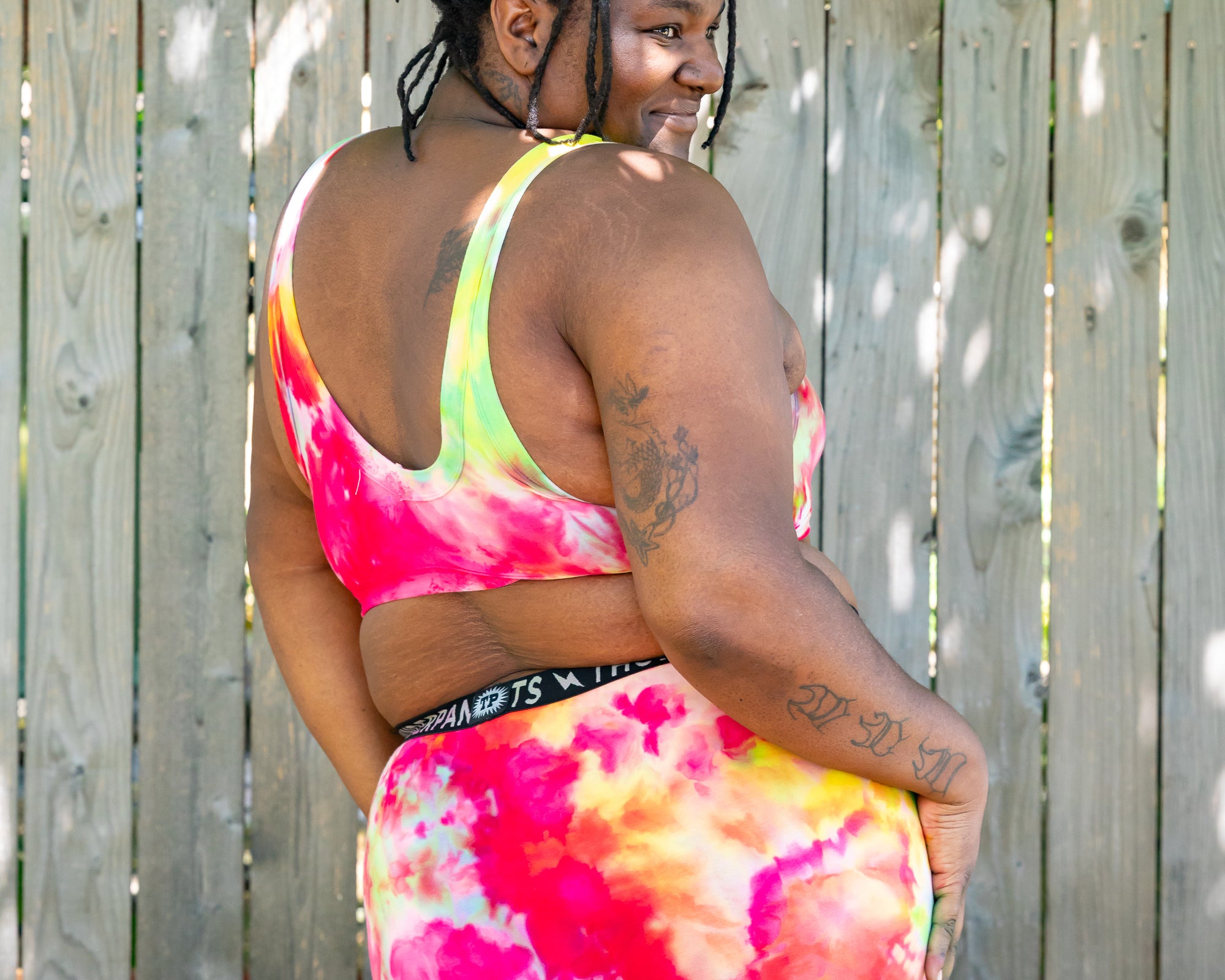 Model wearing Thunderpants Boxer brief style underwear and Bralette in Summer Crush Ice Dye - pinks, blues, yellows. 