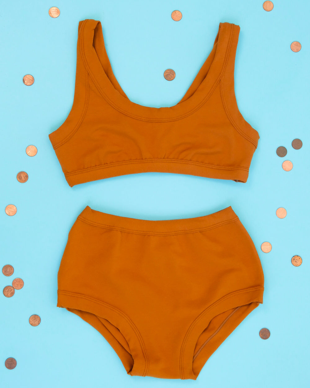 Flat lay of Thunderpants Bralette and Original style underwear  in Lucky Penny - a rust color.