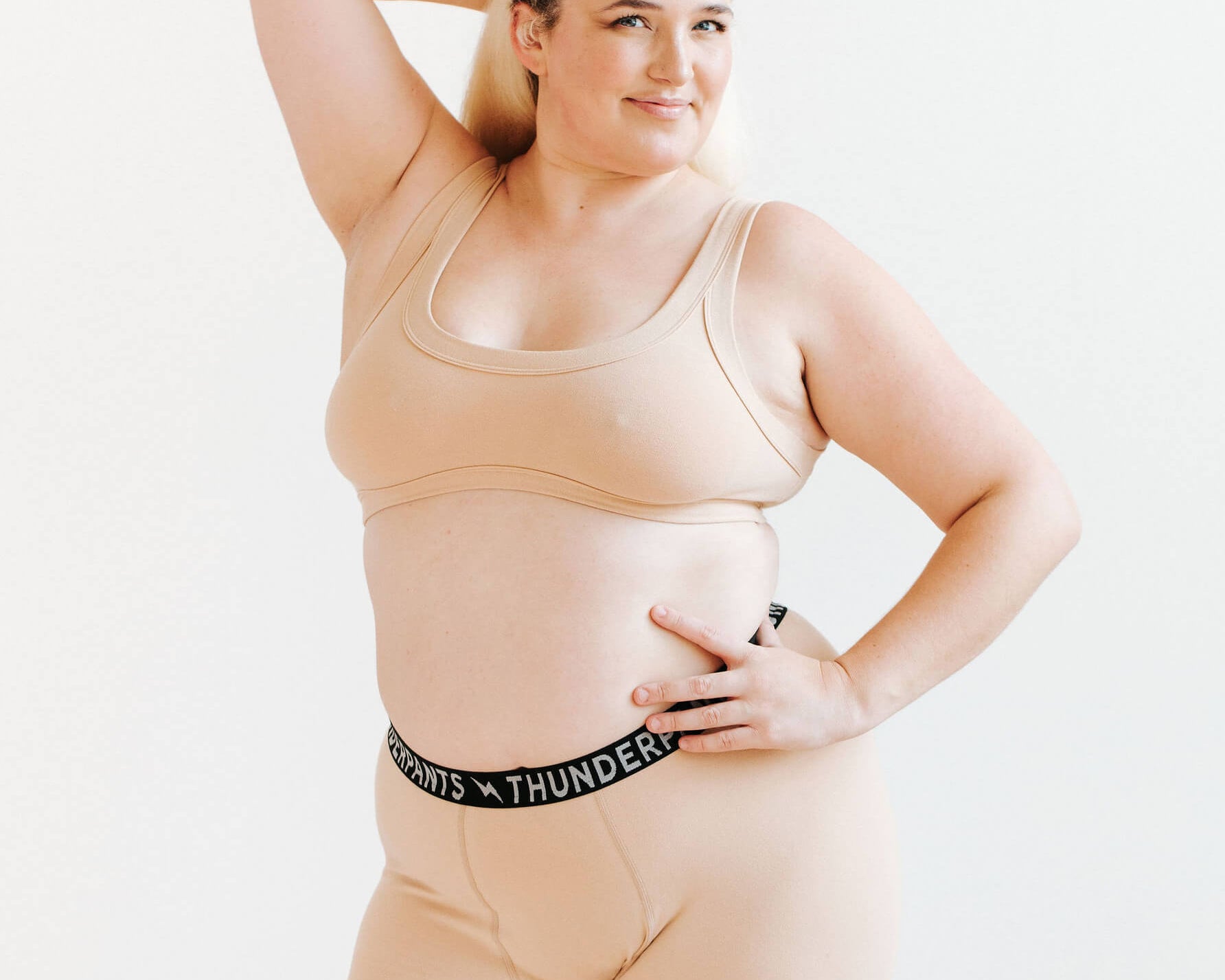 Model wearing Thunderpants Bralette and Boxer Brief in Pine Nut - lighter tan color.