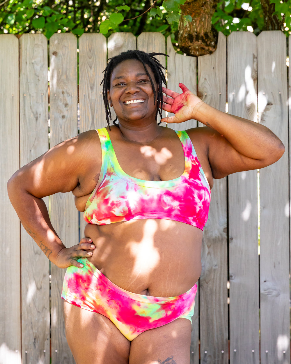 Model wearing Thunderpants Hipster style underwear rand Bralette in Summer Crush Ice Dye - pink, green, and yellow.