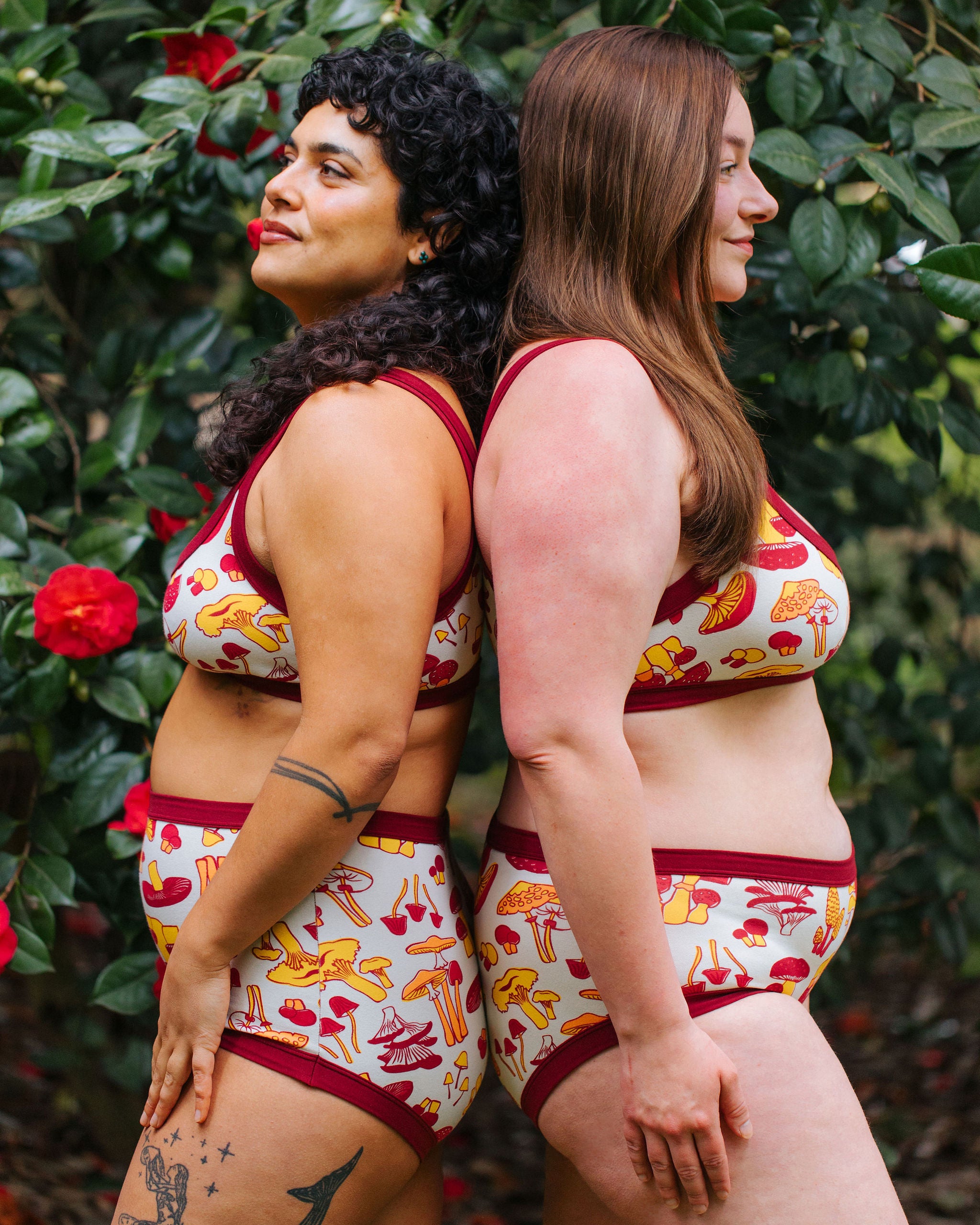 Two models wearing Thunderpants Bralette and underwear in Whadda Fungi print - red, yellow, and orange mushroom print.