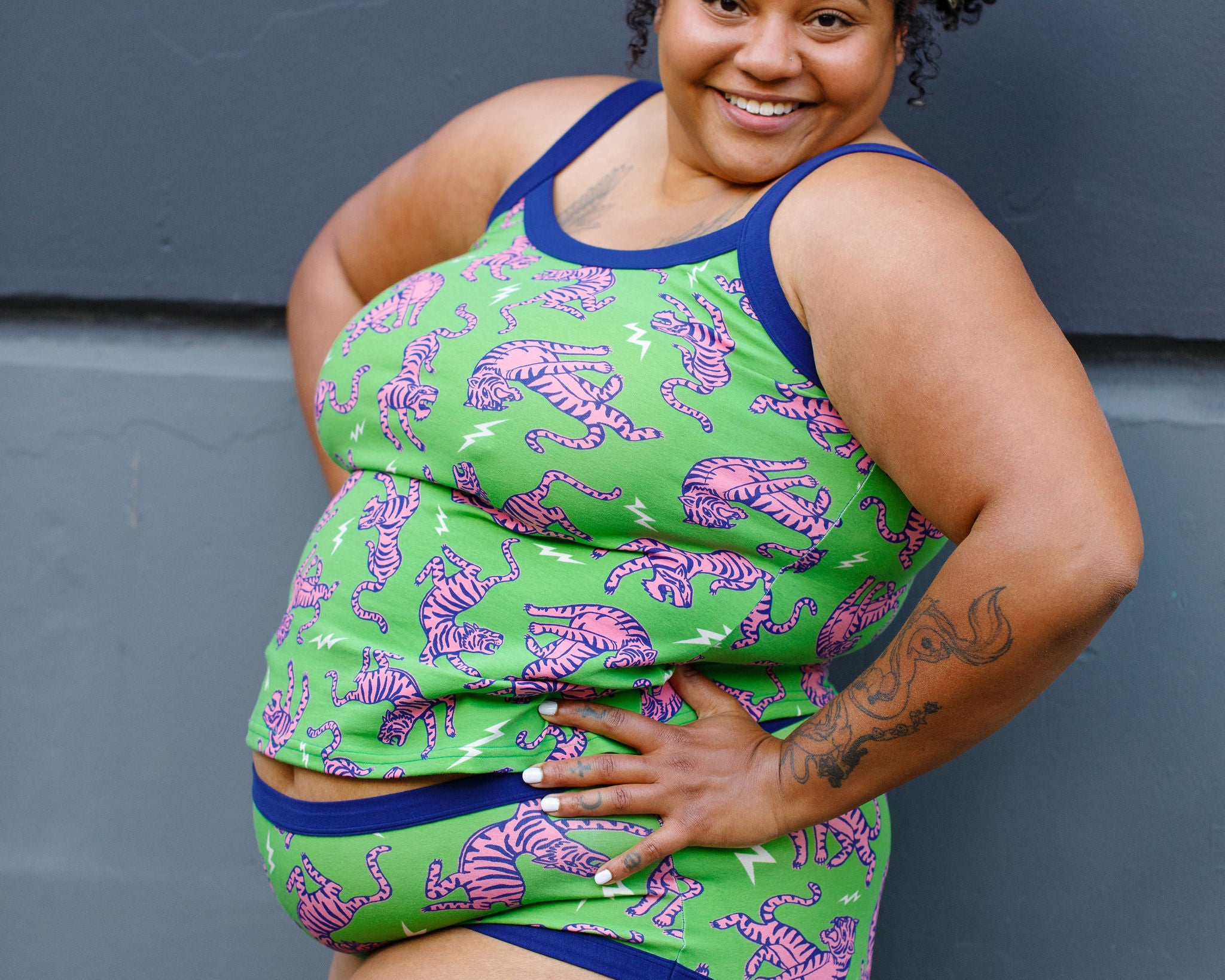 Model wearing Thunderpants organic cotton Cami and Hipster style underwear in Electric Tiger - green with pink and blue tigers and white lightning bolts.