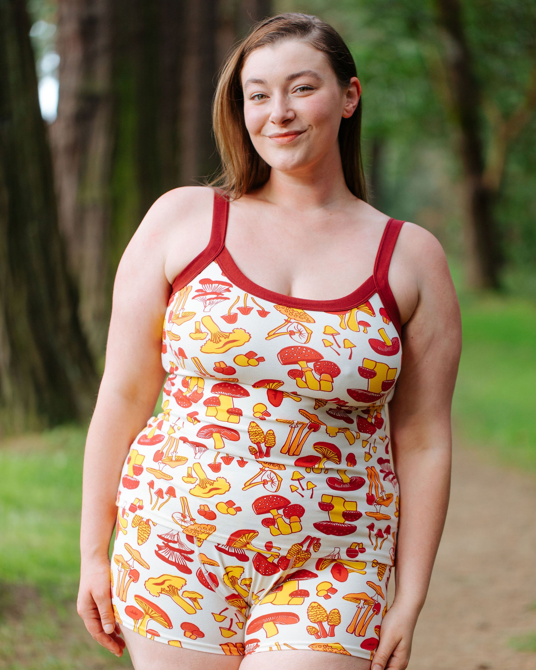Model wearing Thunderpants Cami and Boxer Brief style underwear in Whadda Fungi - red, yellow, and orange mushroom print.