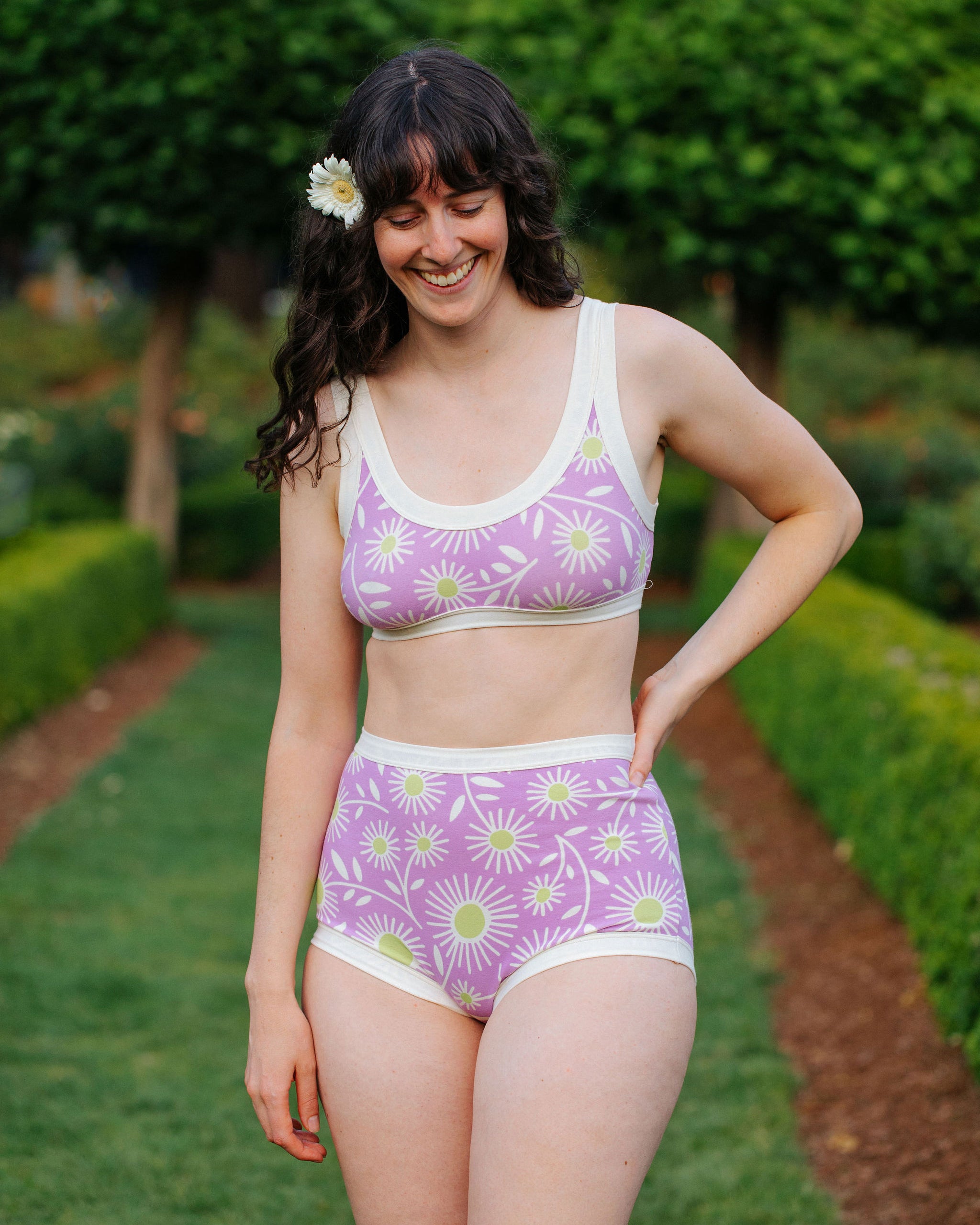 Model wearing Thunderpants Sky Rise style underwear in Delia's Daisy - white, green, and purple daisies print.