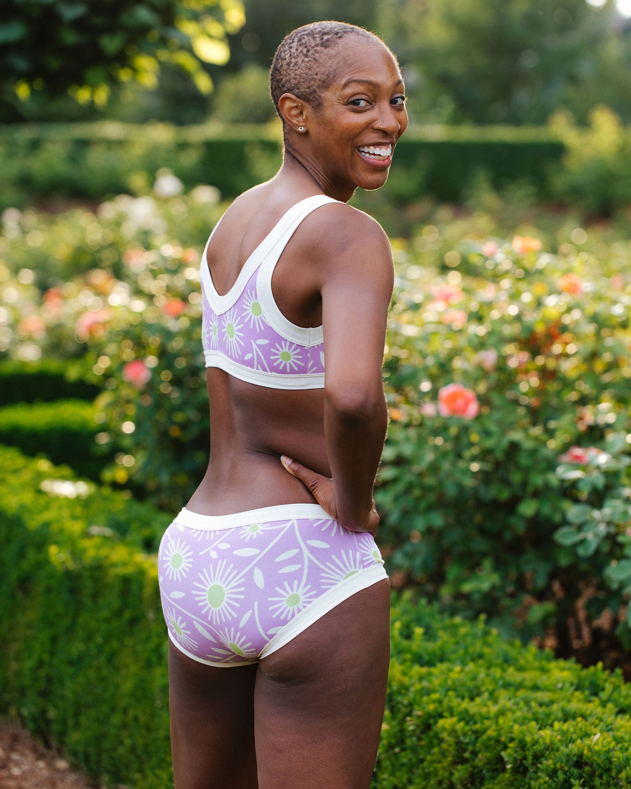 Model wearing Thunderpants Hipster style underwear and Bralette in Delia's Daisy - white, green, and purple daisies print.