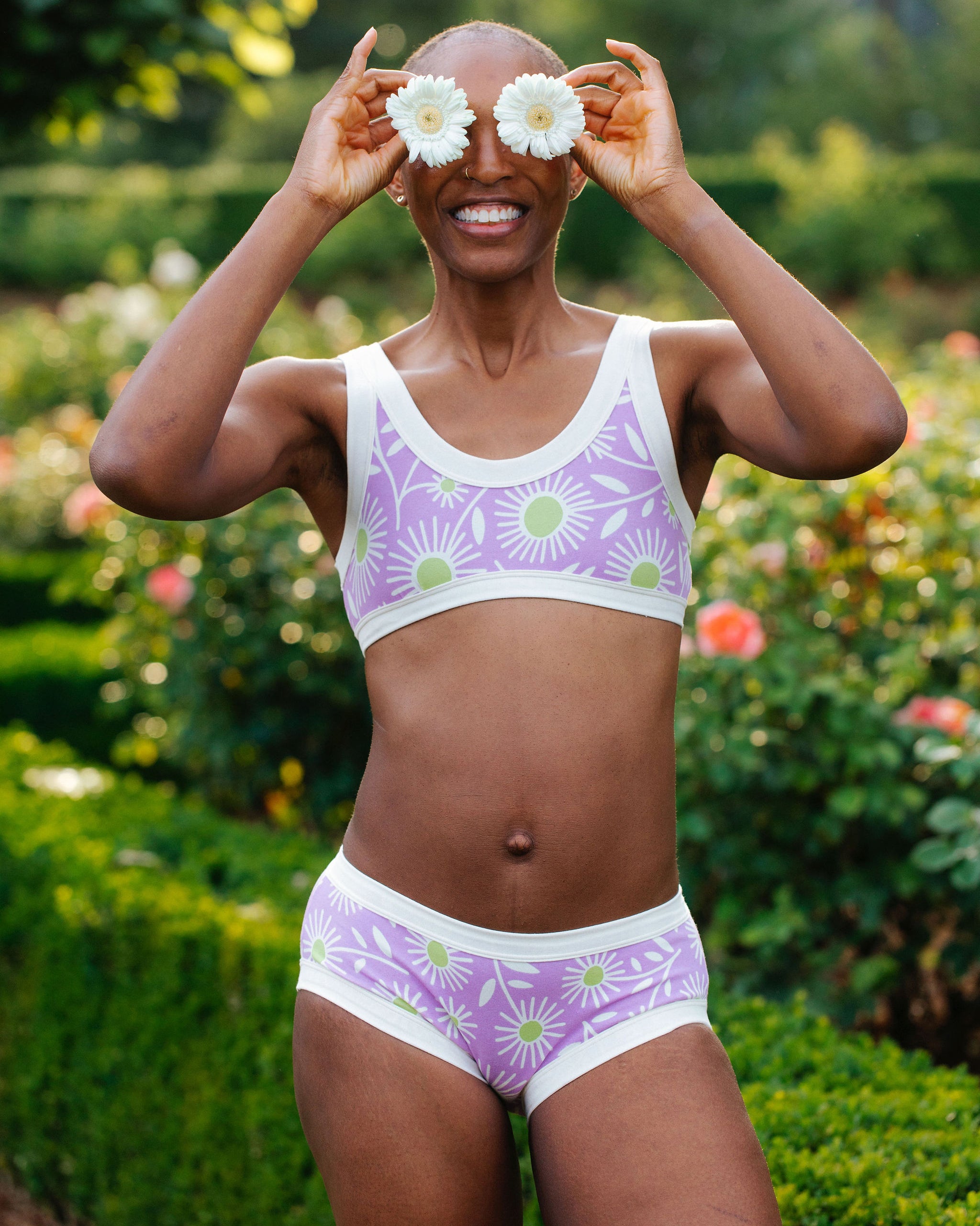 Model wearing Thunderpants Hipster style underwear and Bralette in Delia's Daisy - white, green, and purple daisies print.