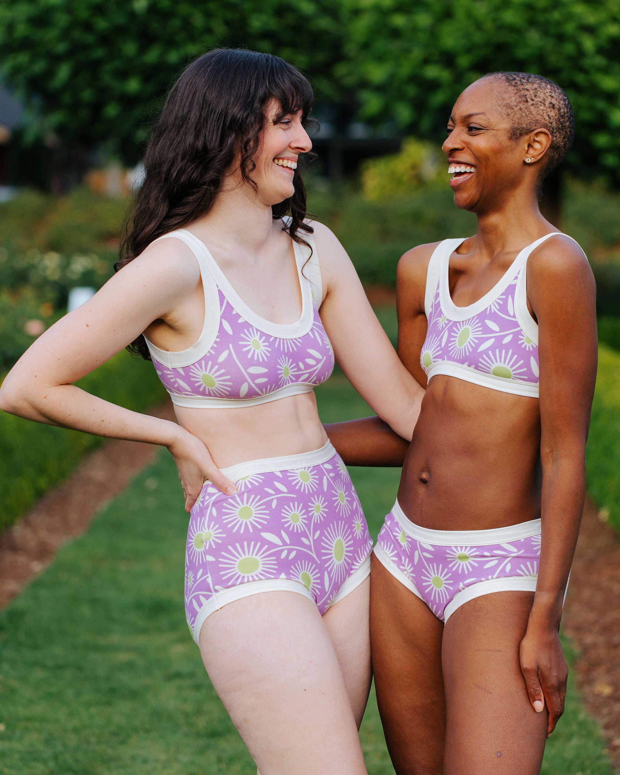 Models wearing Thunderpants Hipster style underwear and Bralettes in Delia's Daisy - white, green, and purple daisies print.