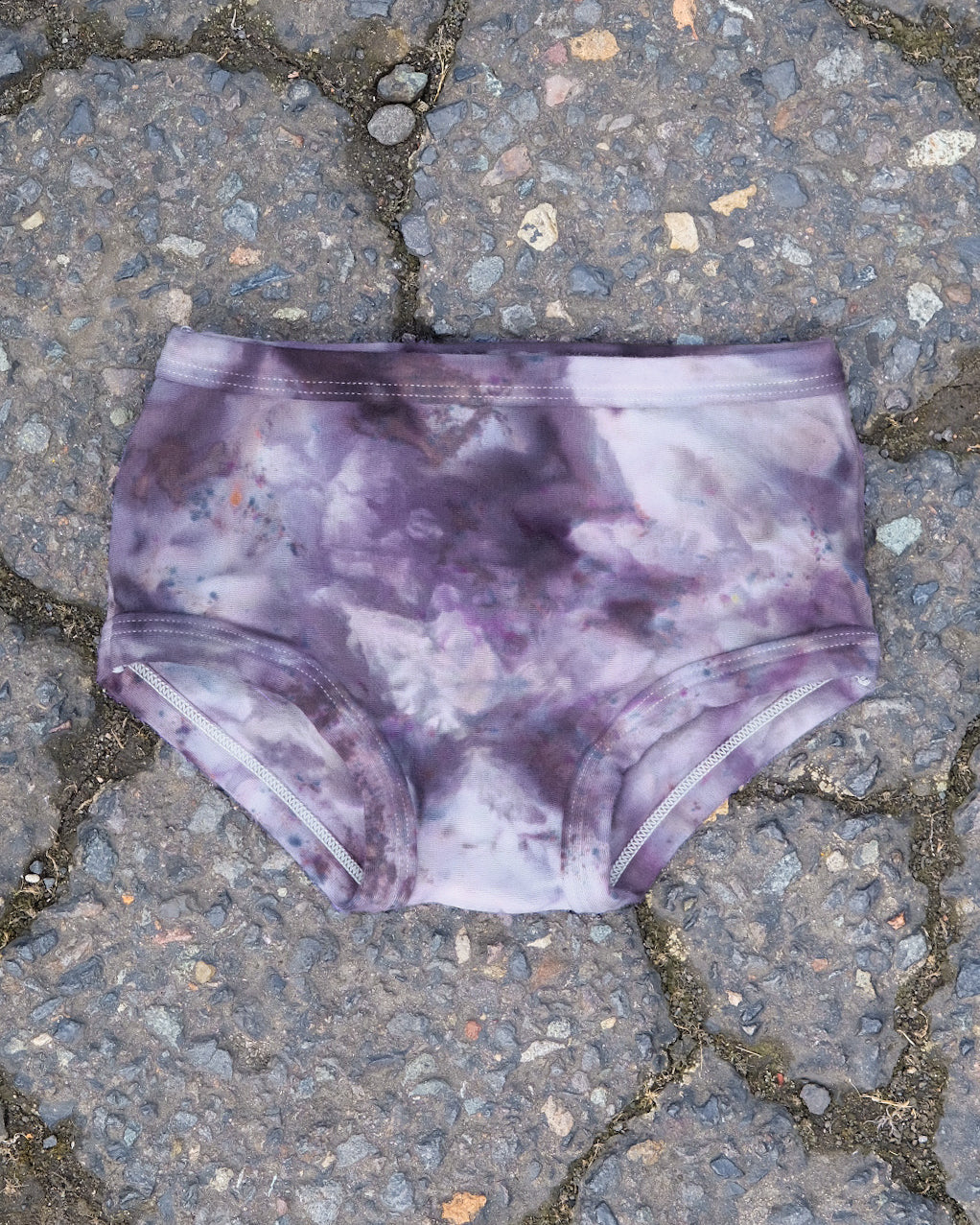 Flat lay of Thunderpants Kid's Original style underwear in Haunted Haze Ice Dye - purply grey dye pattern.