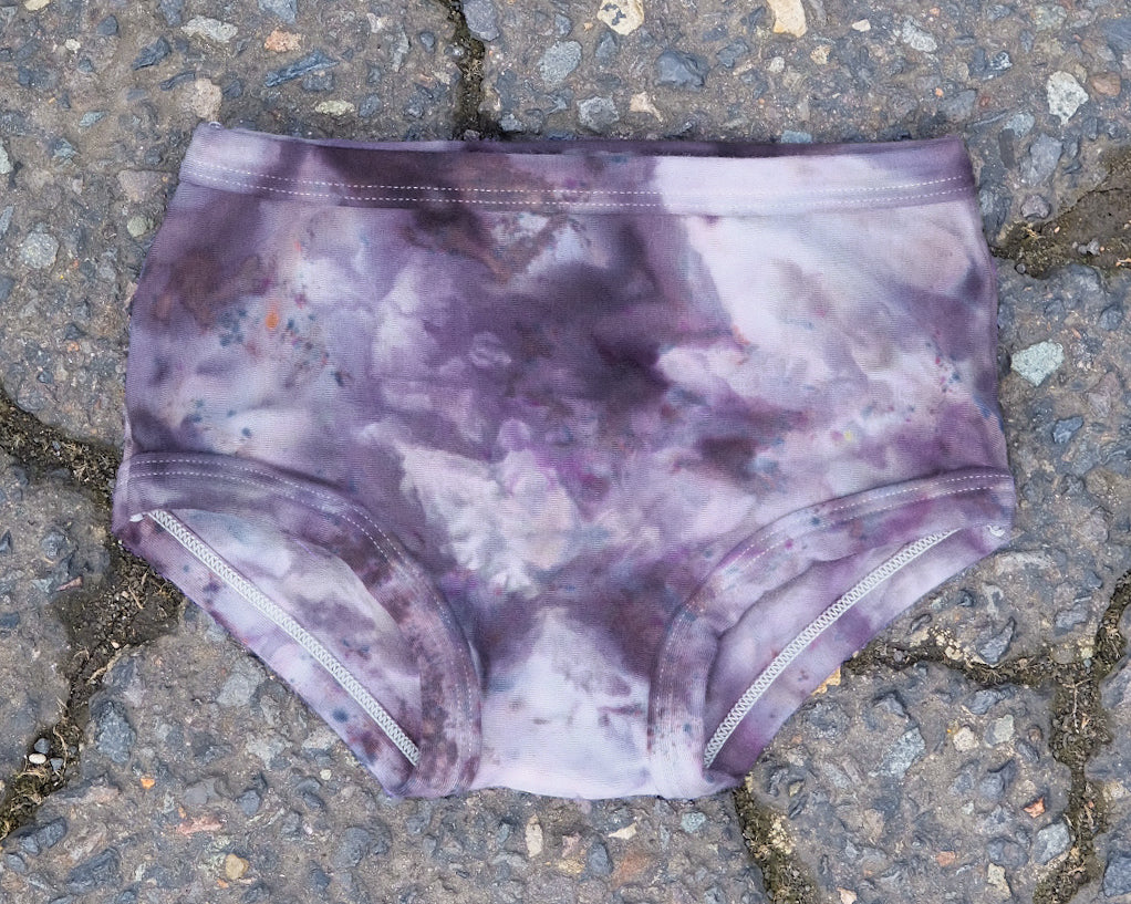 Flat lay of Thunderpants Kid's Original style underwear in Haunted Haze Ice Dye - purply grey dye pattern.