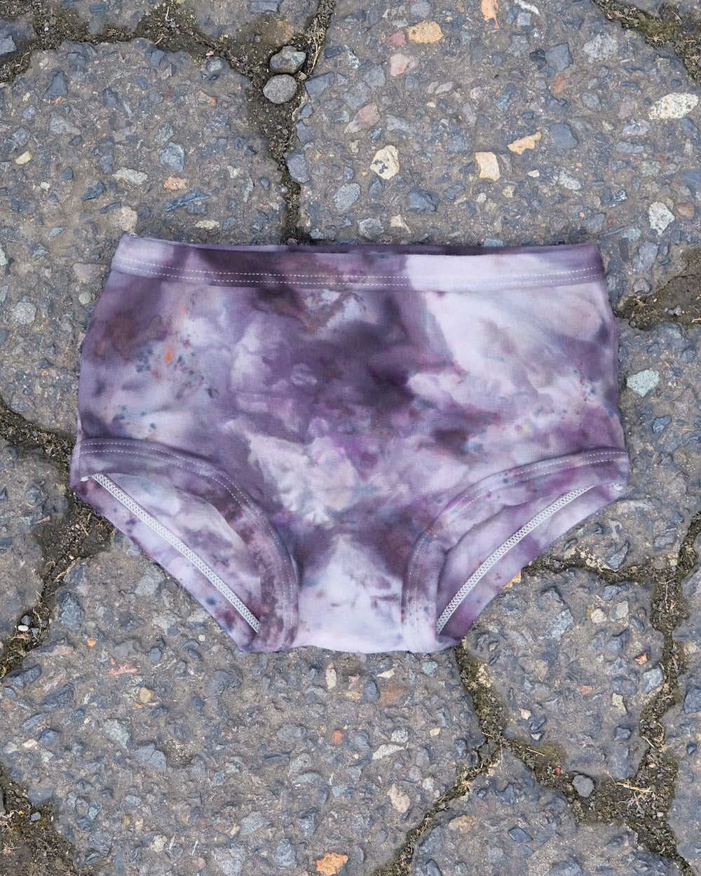 Flat lay of Thunderpants Kid's Original style underwear in Haunted Haze Ice Dye - purply grey dye pattern.