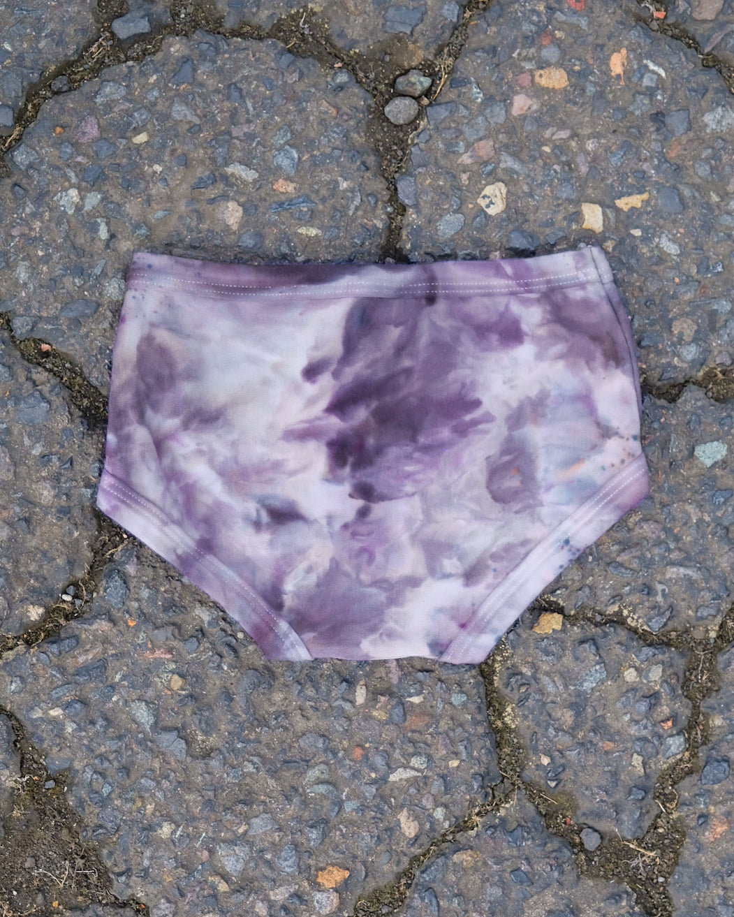 Flat lay of Thunderpants Kid's Original style underwear in Haunted Haze Ice Dye - purply grey dye pattern.