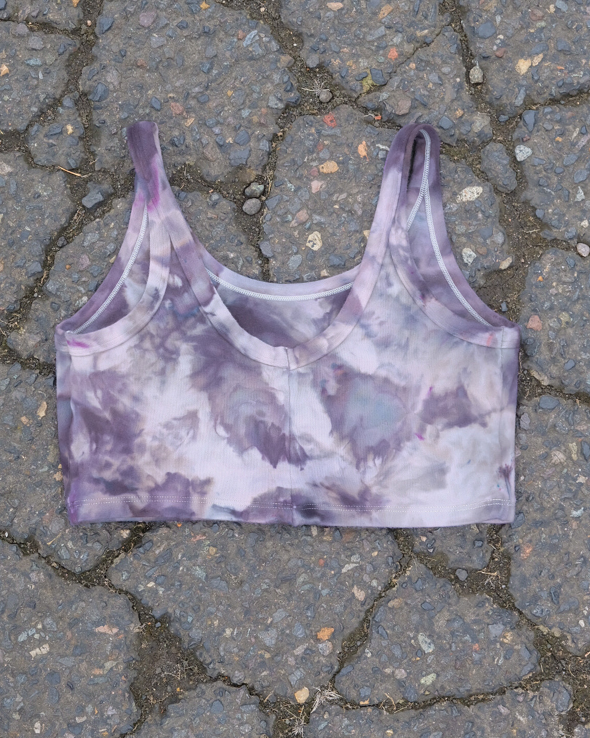 Flat lay of Thunderpants Longline Bra in Haunted Haze Ice Dye - purply grey dye pattern.