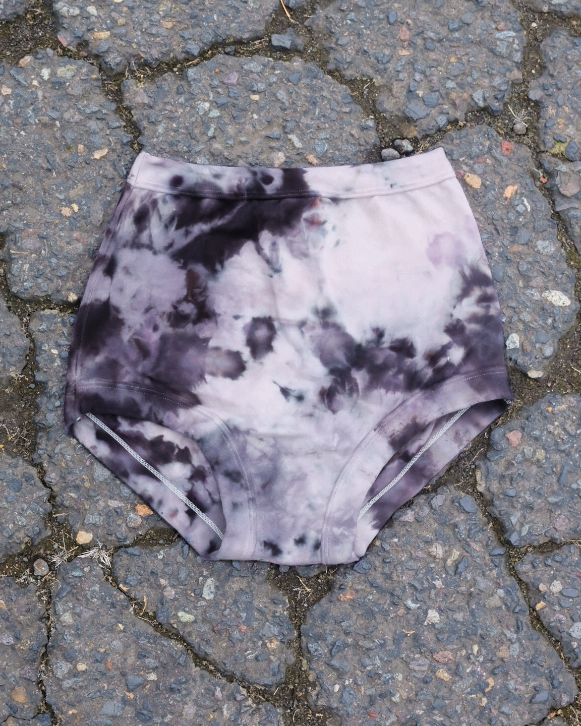 Flat lay of Thunderpants Sky Rise style underwear in Haunted Haze Ice Dye - purply grey dye pattern.