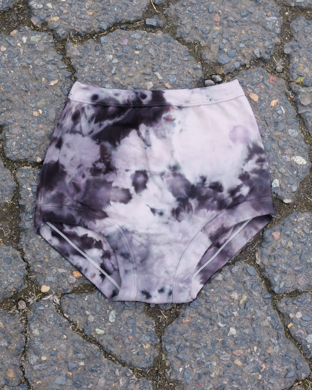 Flat lay of Thunderpants Sky Rise style underwear in Haunted Haze Ice Dye - purply grey dye pattern.