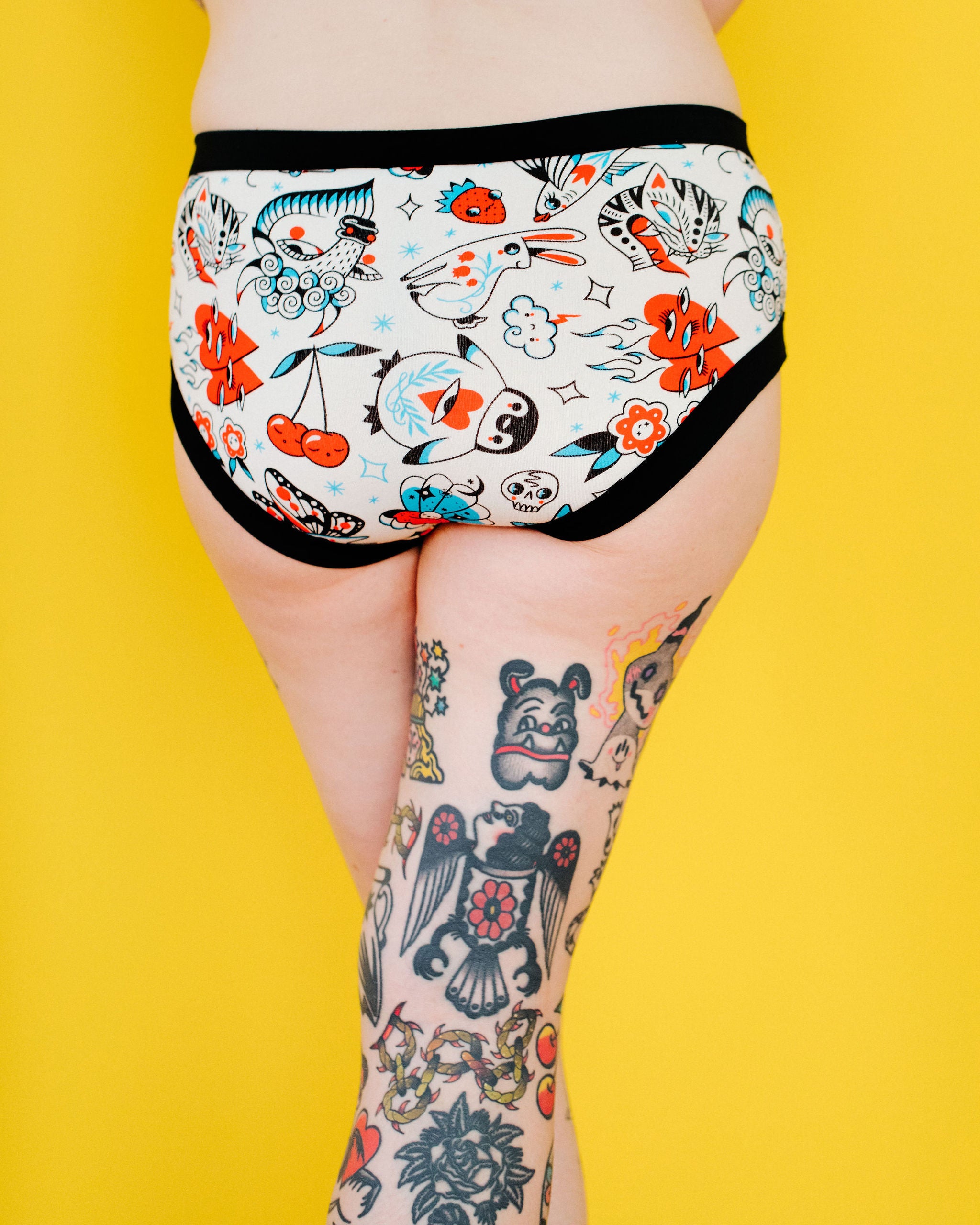 Model wearing Thunderpants Hipster style underwear in Inked Up - a tattoo pattern with black, red, and blue. 