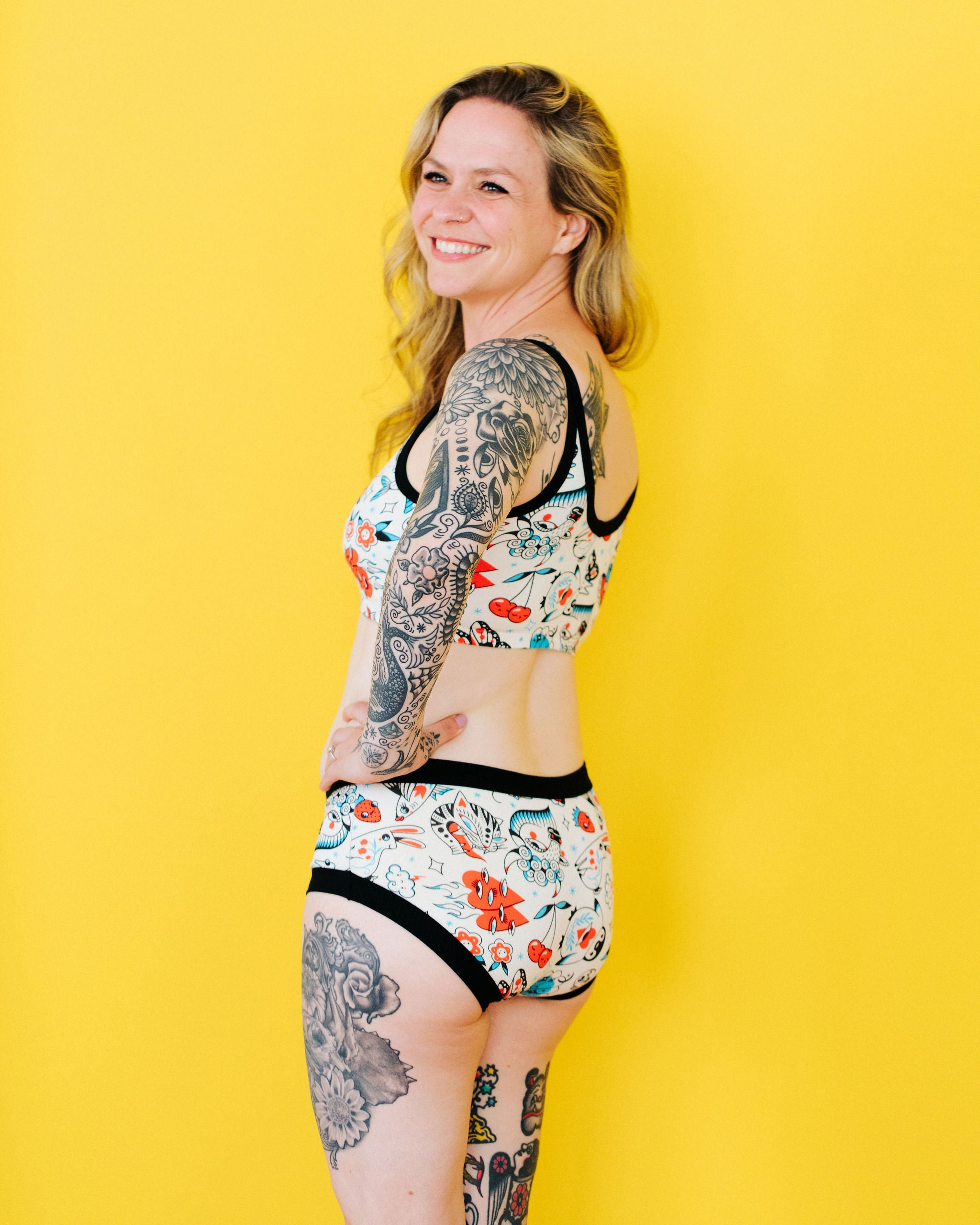 Model wearing Thunderpants Hipster style underwear and Longline Bra in Inked Up - a tattoo pattern with black, red, and blue. 