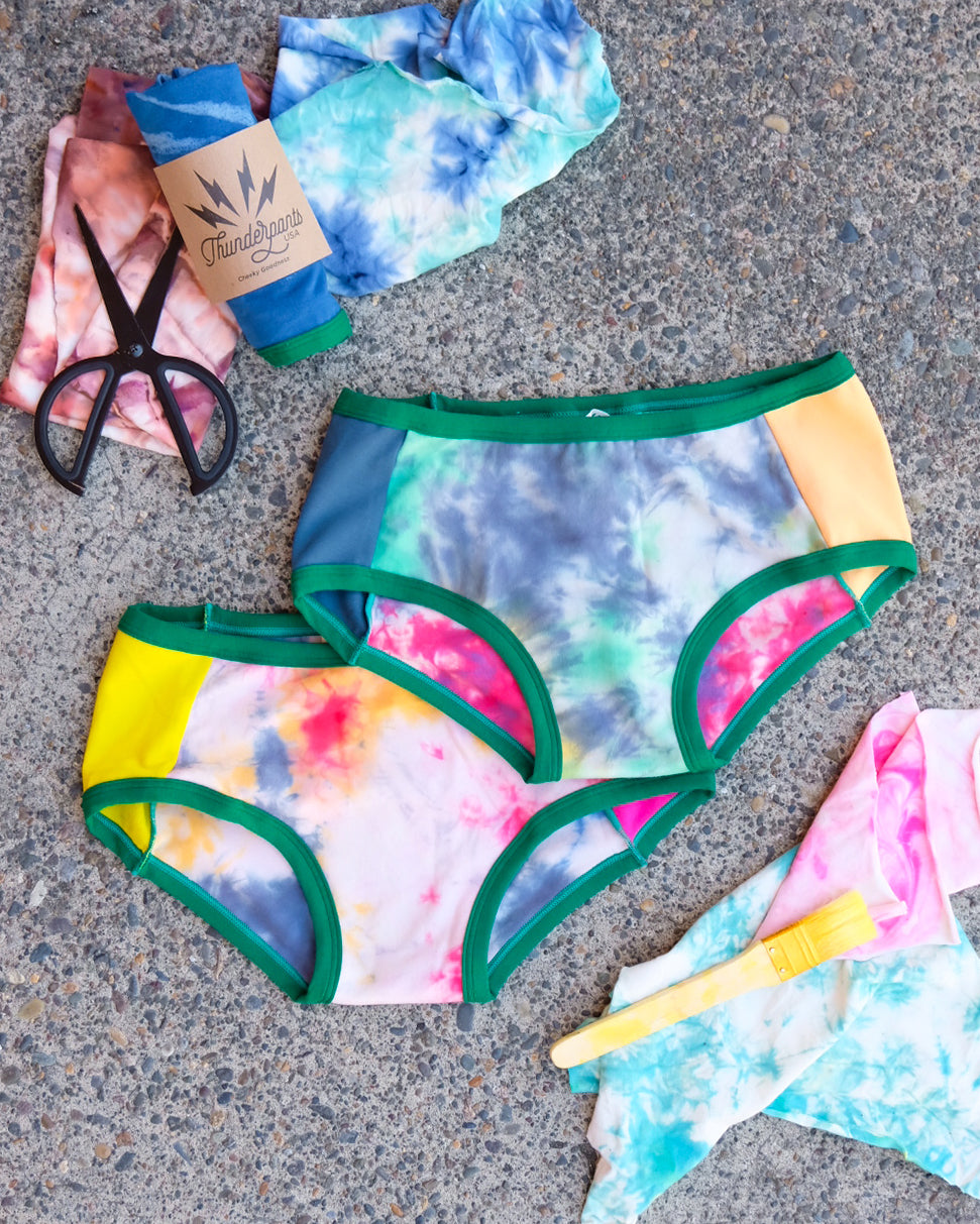 Flat lay of two pairs of Thunderpants Hipster style underwear in Dye Scrap Panel Pants - a mix of solids and dyed fabrics.