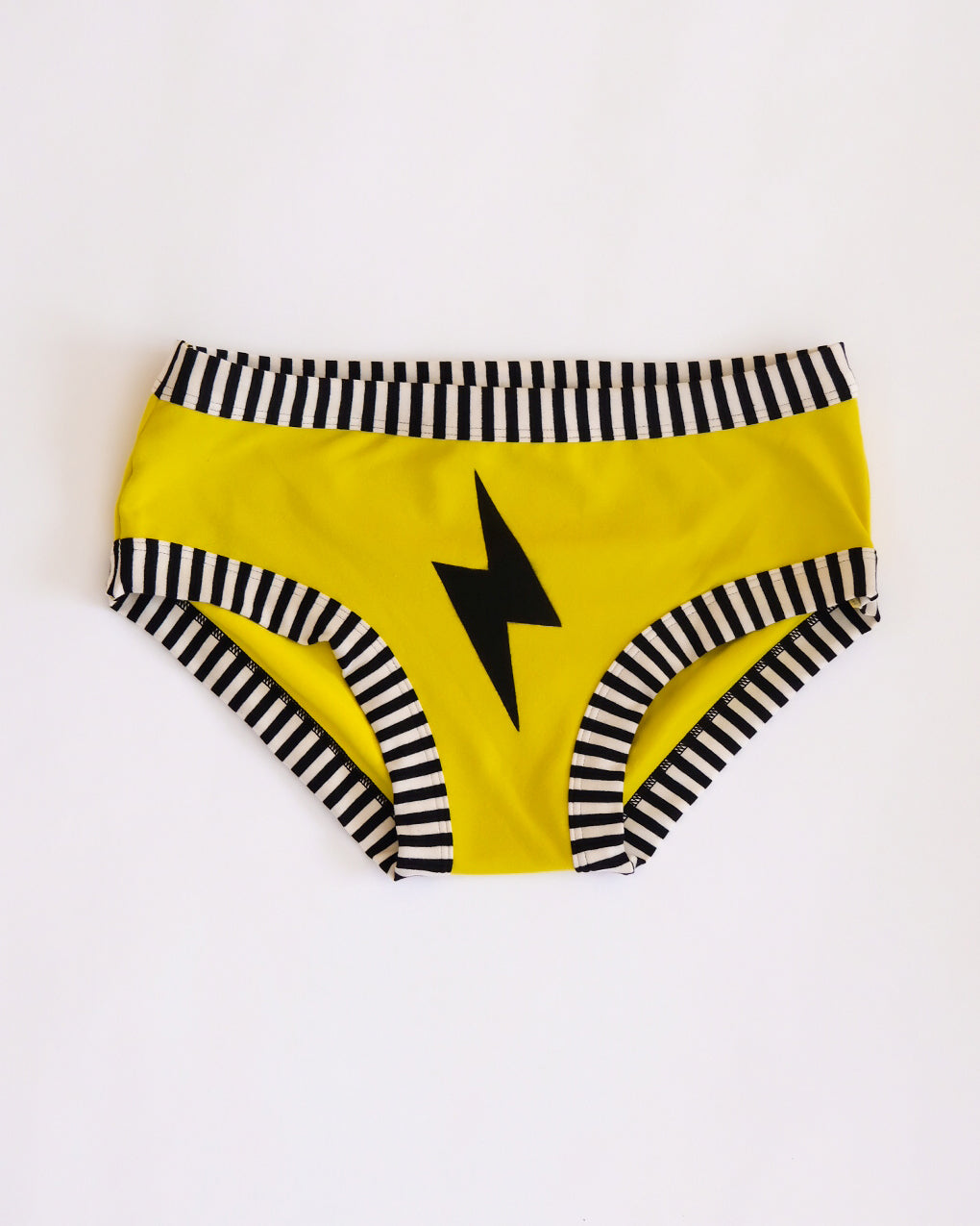 Flat lay of Thunderpants Hipster style underwear in Thunderstruck - yellow with a black lightning bolt.