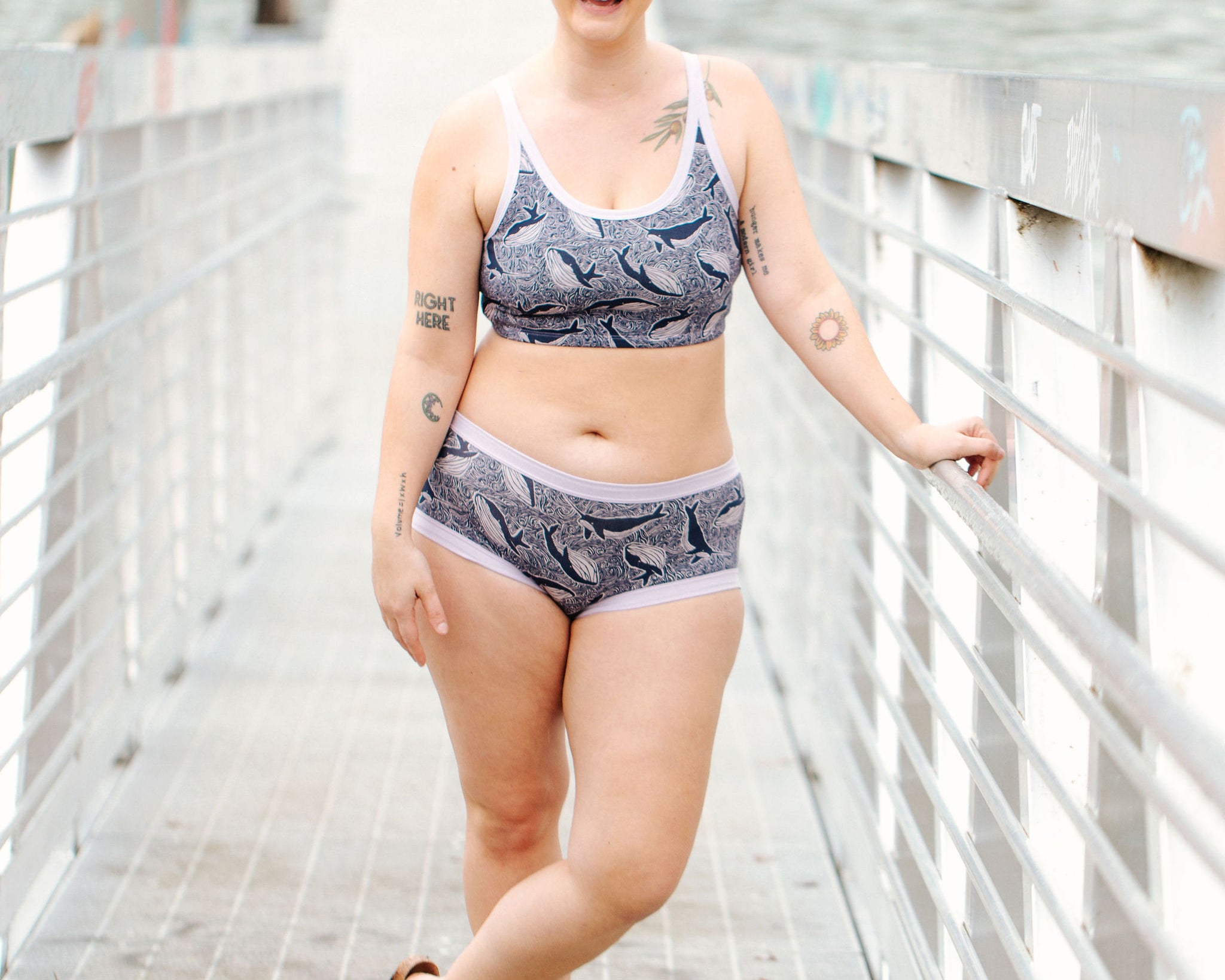 Model wearing Thunderpants Hipster style underwear and Longline Bra in Whale, Whale, Whale print - indigo whales on lavender.