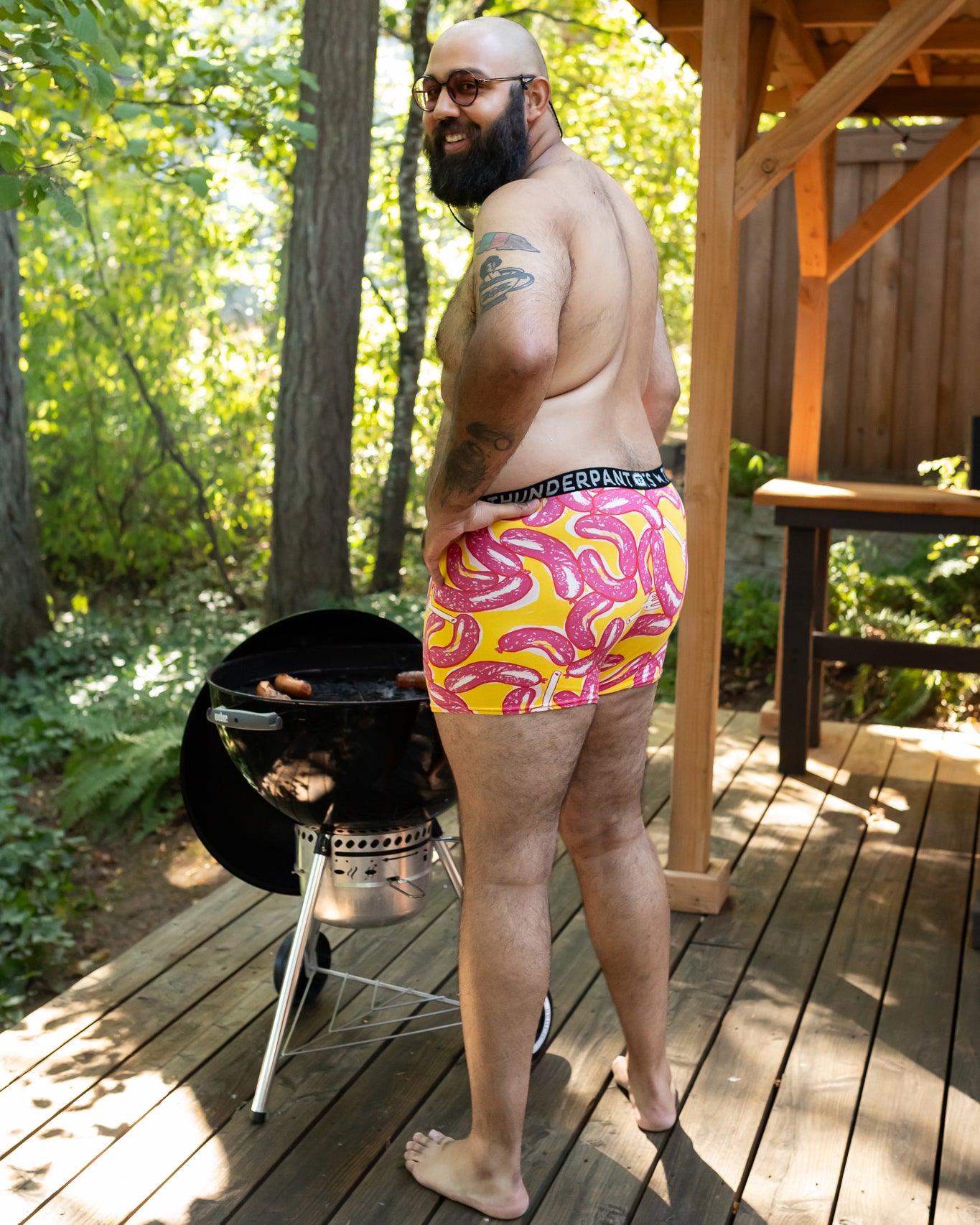 Models wearing Thunderpants Boxer Brief style underwear in Hot Dawg! print - pink sausages on yellow background and red binding.