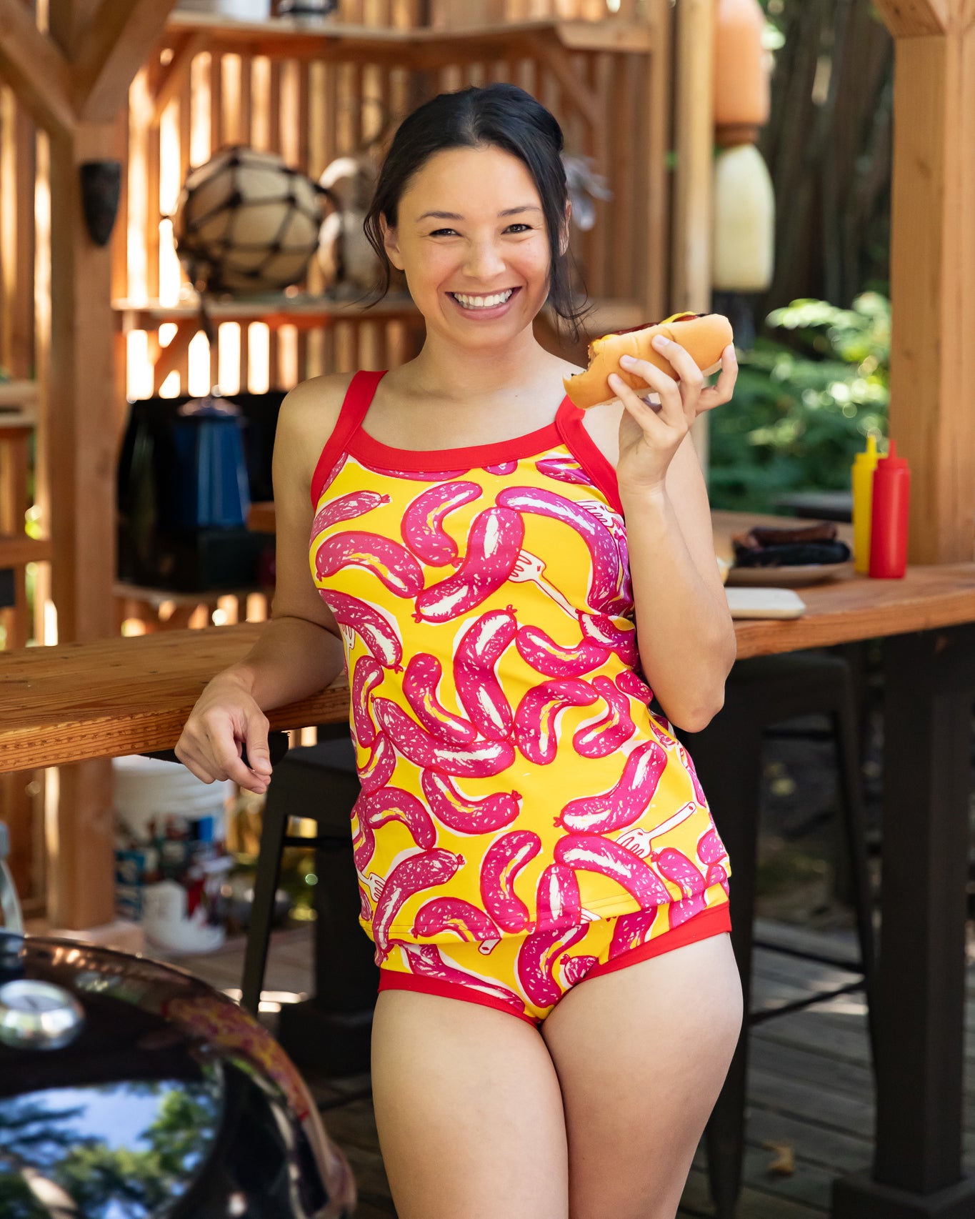 Modeling wearing Thunderpants Cami and Hipster style underwear in Hot Dawg! print - pink sausages on yellow background and red binding.