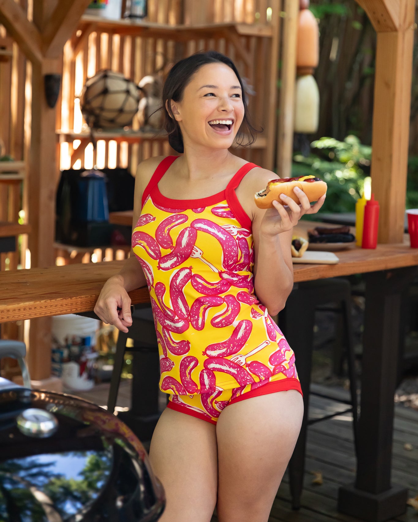 Modeling wearing Thunderpants Cami and Hipster style underwear in Hot Dawg! print - pink sausages on yellow background and red binding.