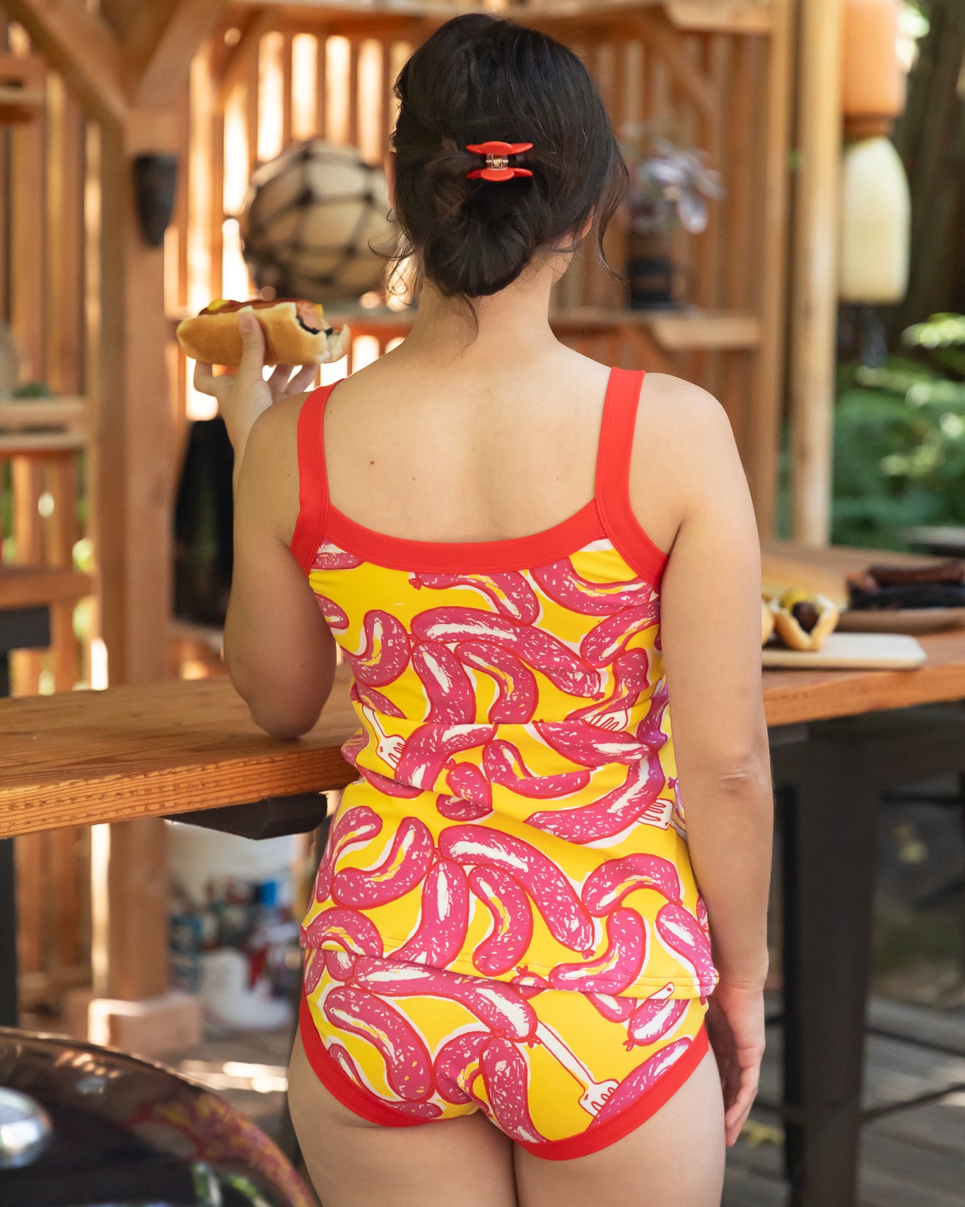 Modeling wearing Thunderpants Cami and Hipster style underwear in Hot Dawg! print - pink sausages on yellow background and red binding.