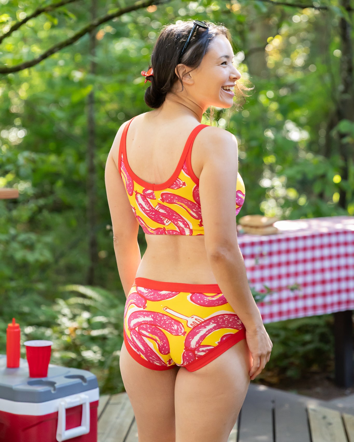 Model wearing Thunderpants Hipster style underwear and Longline Bra in Hot Dawg! print - pink sausages on yellow background and red binding.