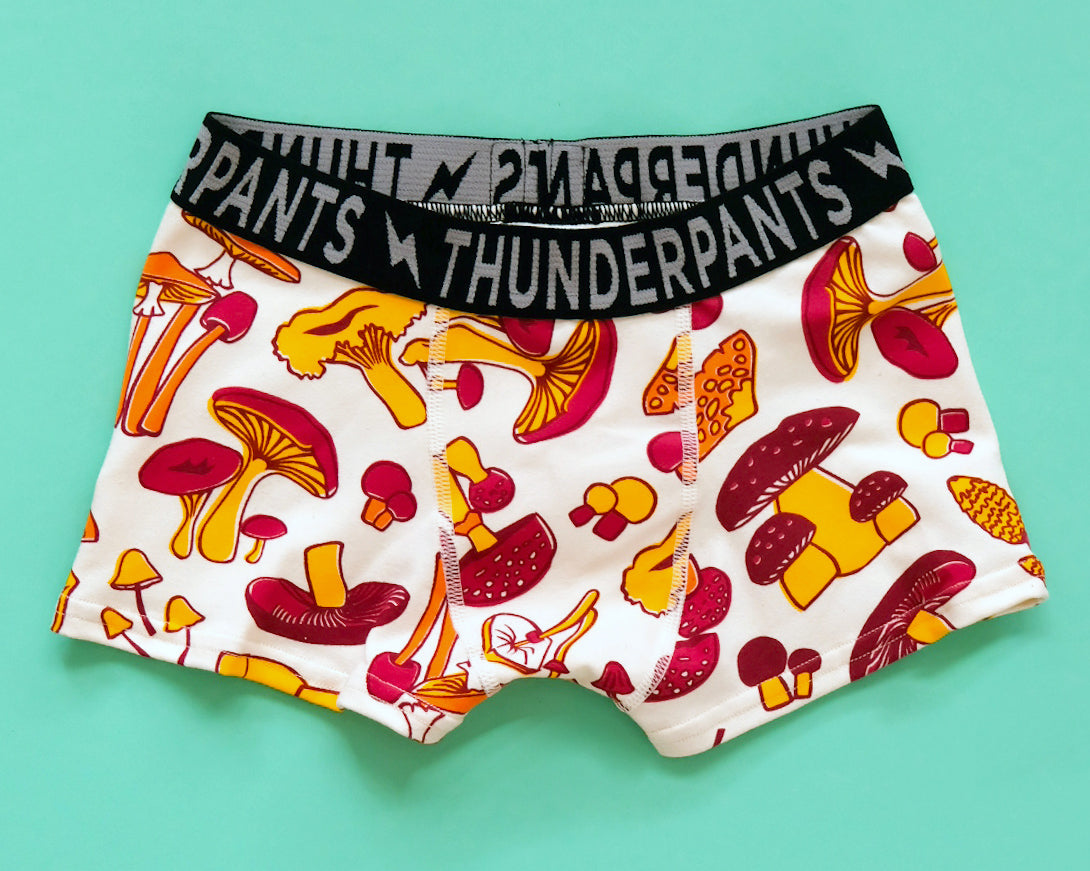 Flat lay of Thunderpants Kids Boxer Brief style underwear in Mushroom print - red, orange, and yellow. 