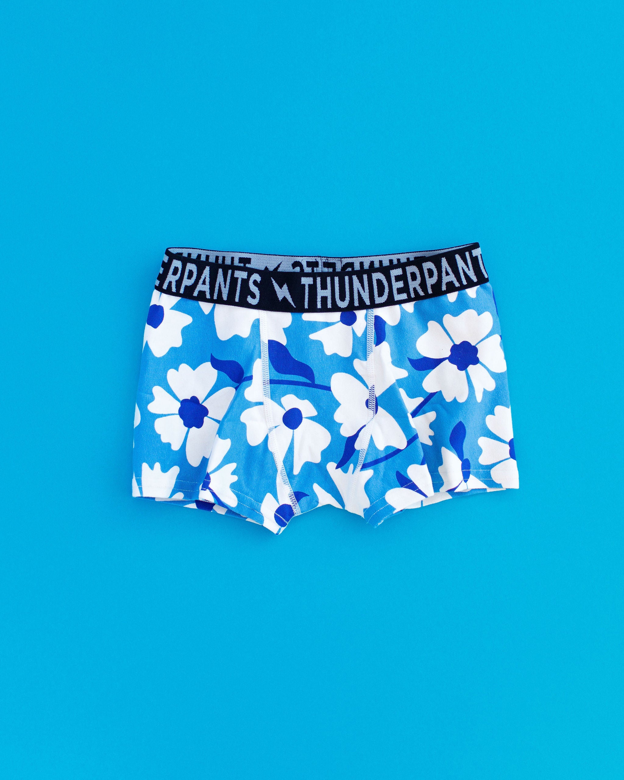 Flat lay of Kids Boxer Brief style underwear in Moody Blues - blue and white flowers.